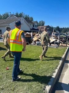 Alaska Army Guardsmen with Joint Task Force – Juneau partner with the Department of Transportation to assist Juneau residents with recovery and cleanup efforts Aug. 8, 2024, following recent flooding after the Mendenhall Glacier’s Suicide Basin released. The State Emergency Operations Center requested 40 members of the Alaska Organized Milita to assist with flood recovery efforts. Seven Guardsmen from Juneau began work Aug. 7, and an additional 33 Air and Army Guard volunteers from the Fairbanks and Anchorage will fly to Juneau in the coming days as part of JTF-J.