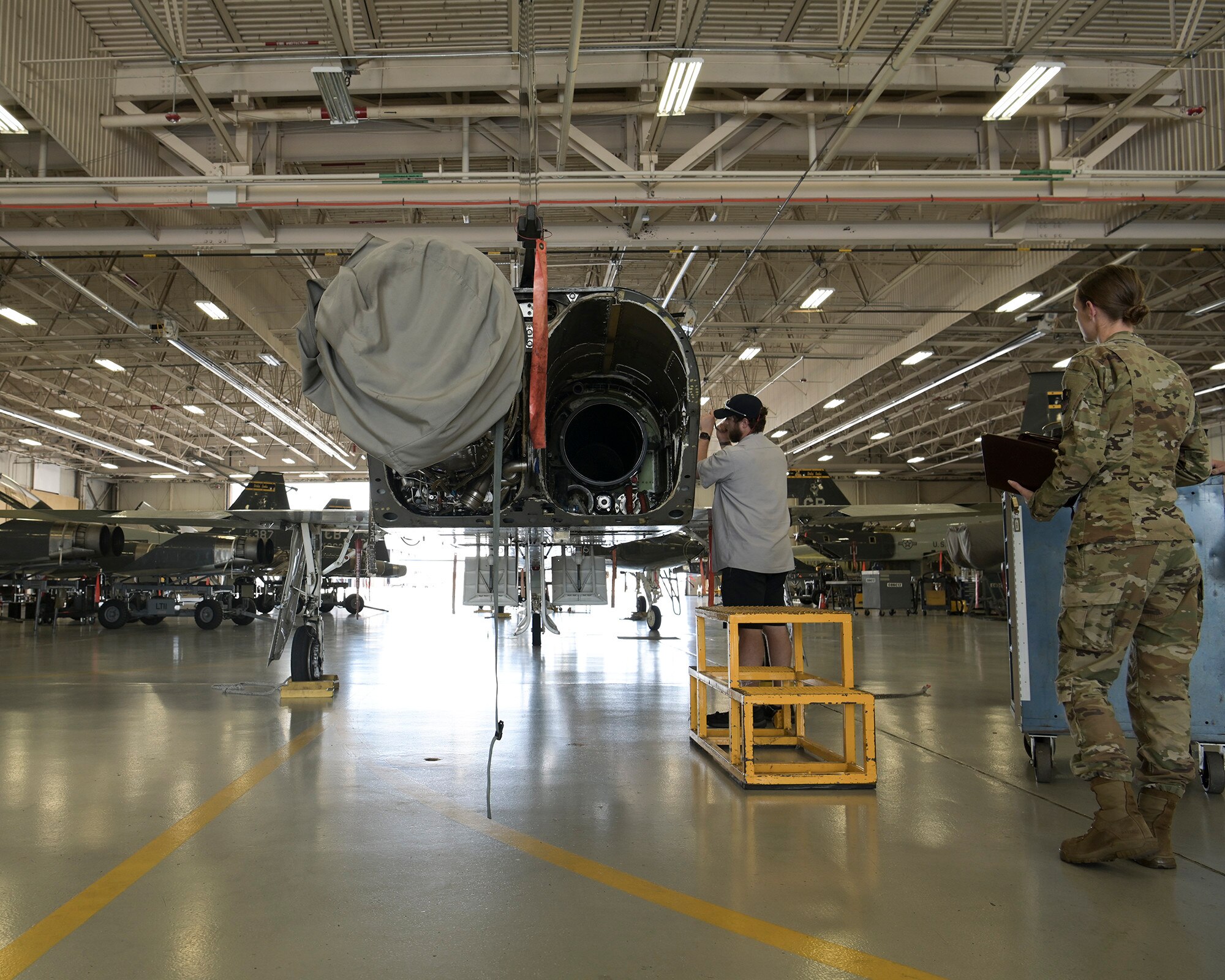 Aircraft maintenance personnel perform maintenance.