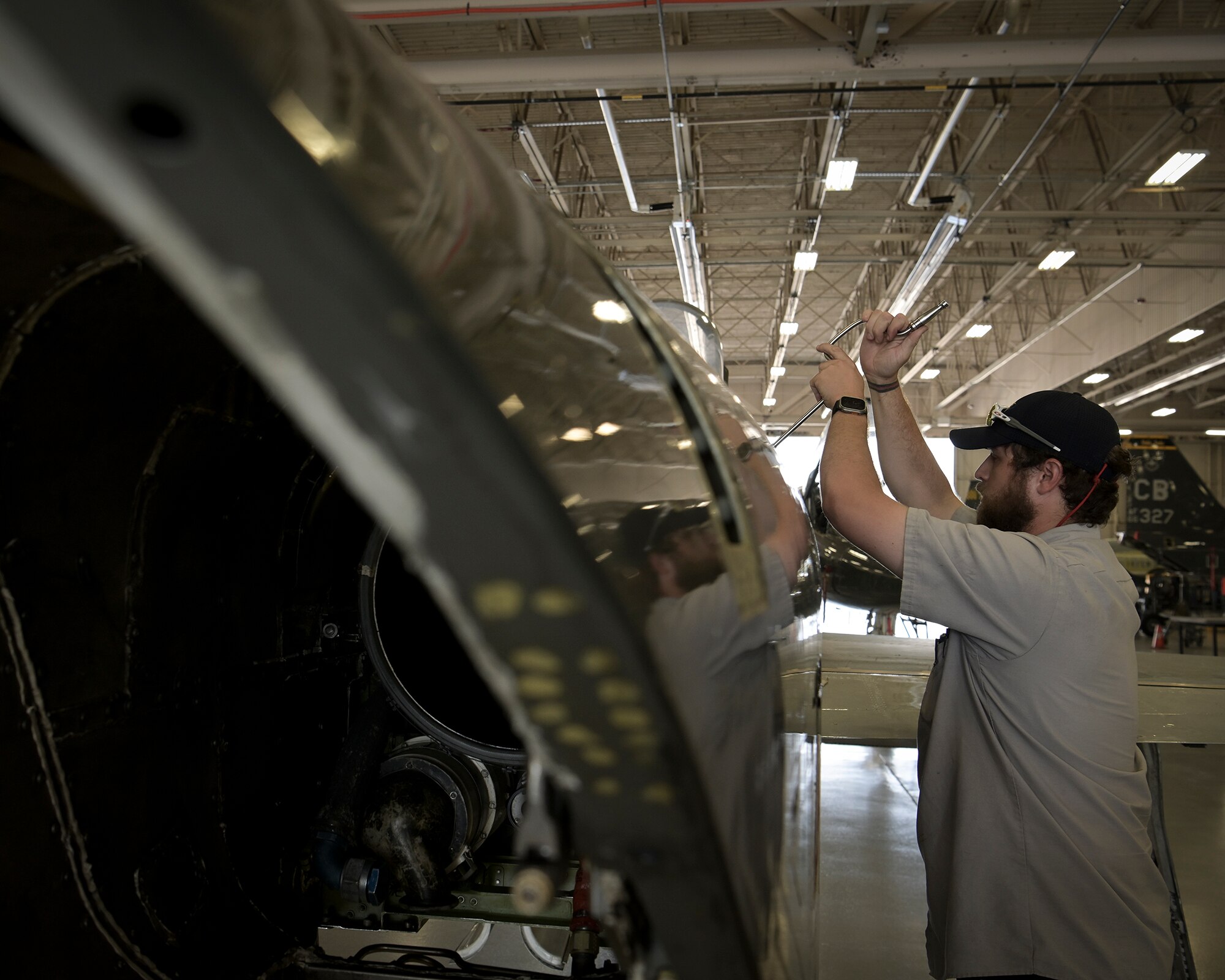Aircraft maintenance personnel perform maintenance.