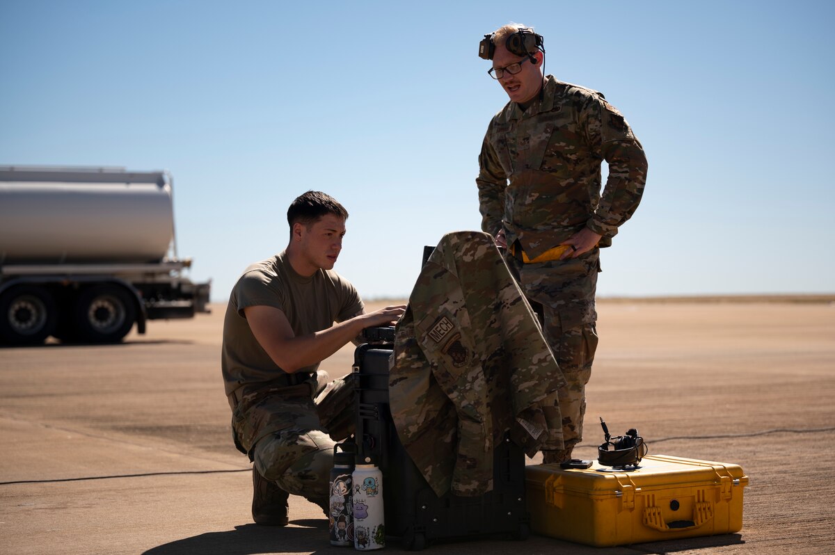 Photo of U.S. Air Force crew chiefs checking equipment