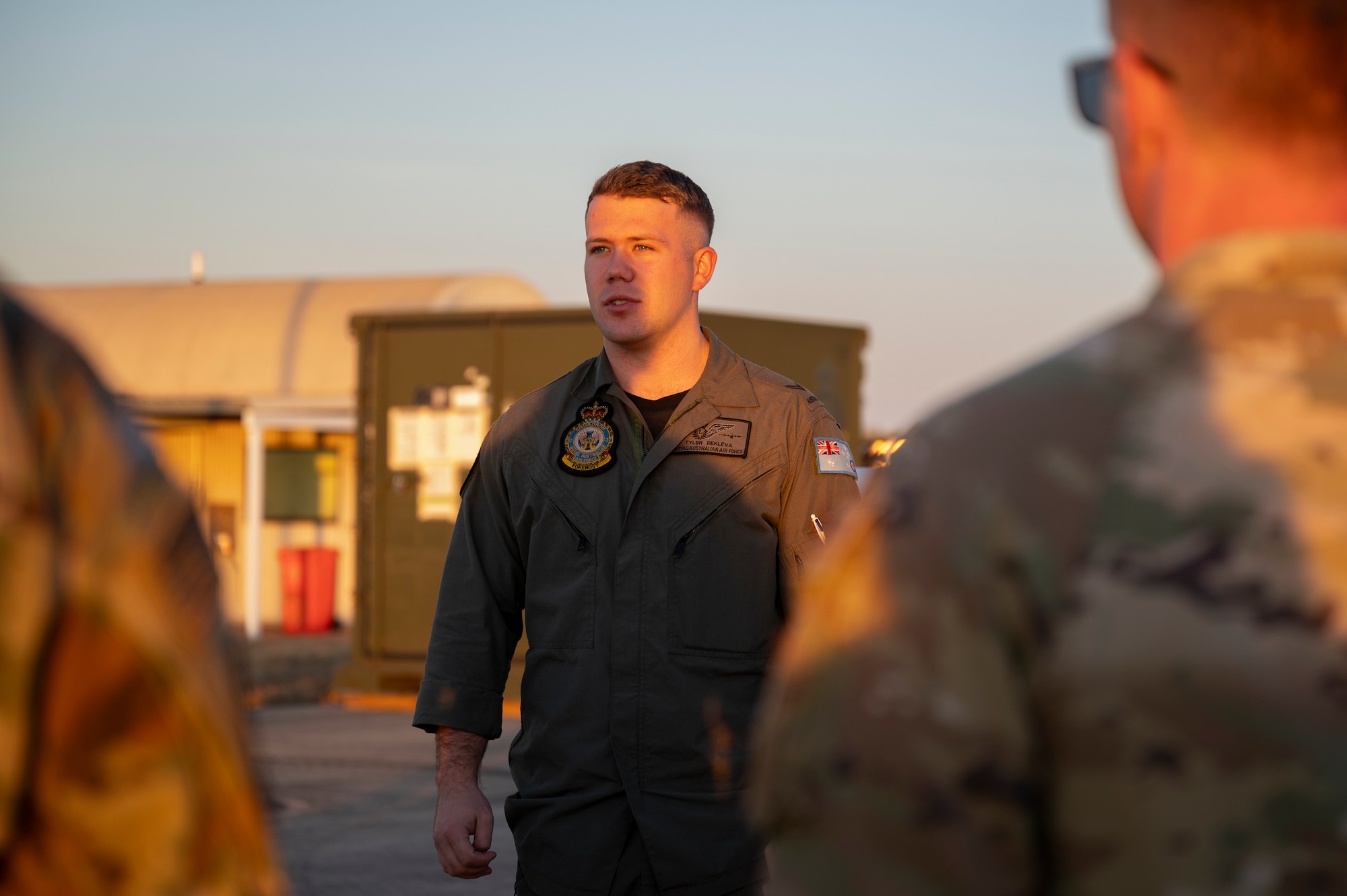 Photo of a Royal Australian Air Force Airman briefing U.S. Air force passengers