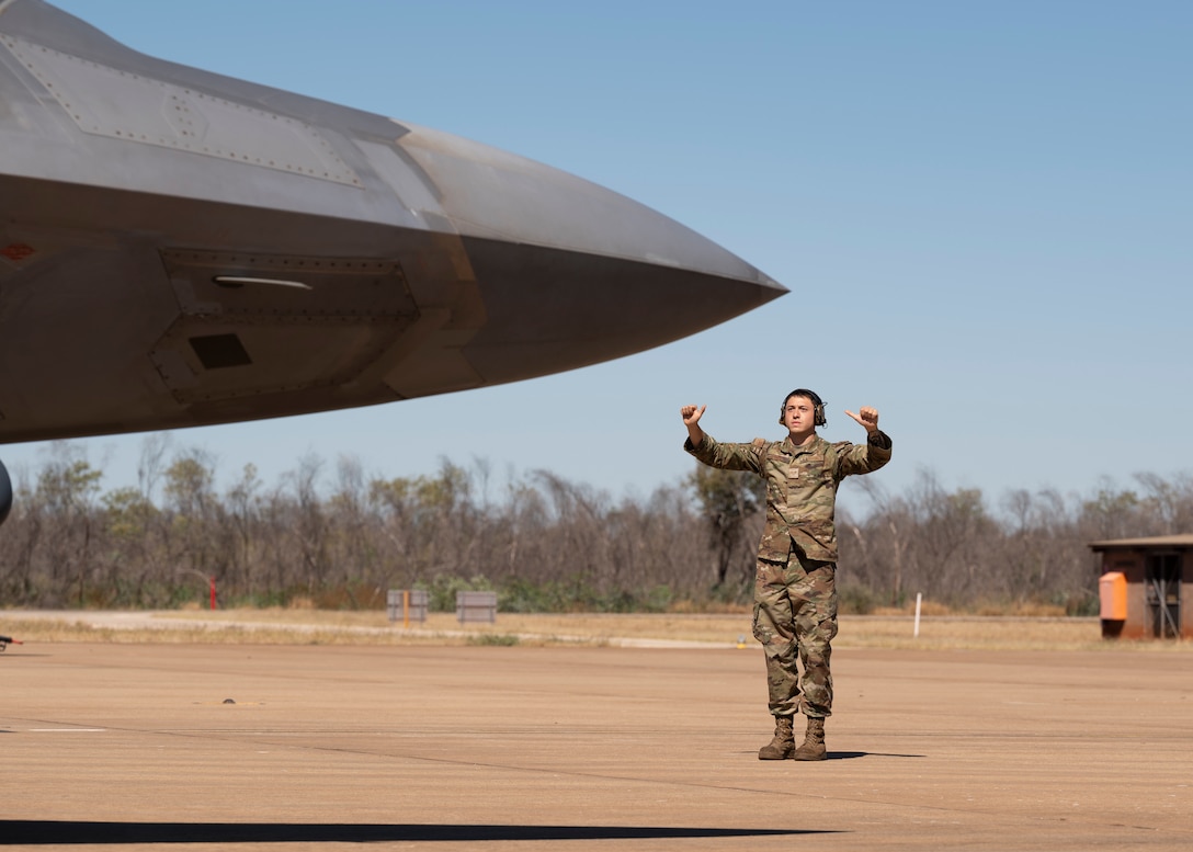 Photo of a U.S. Airmen marshaling and aircraft