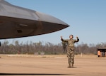 Photo of a U.S. Airmen marshaling and aircraft