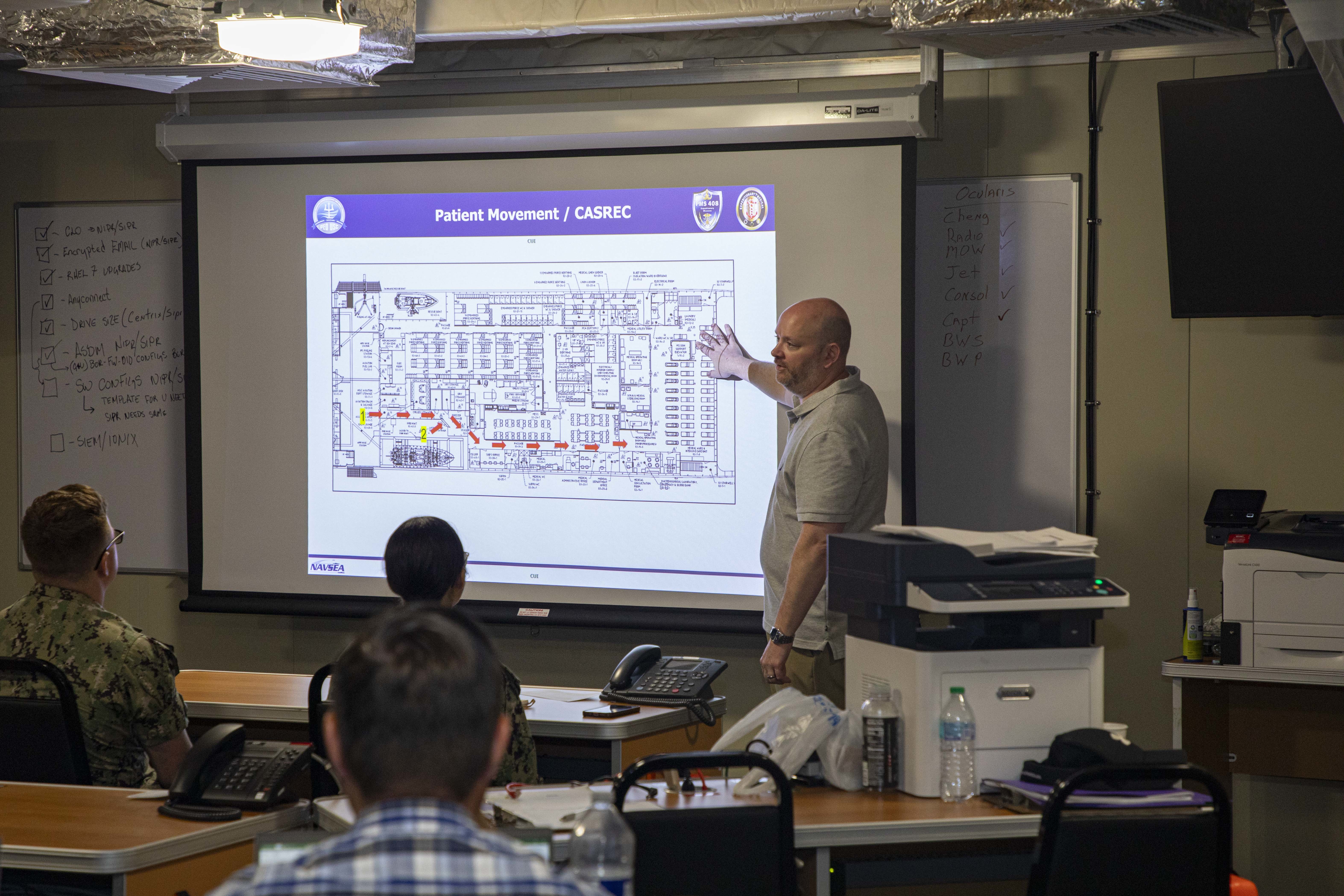 240715-N-KC192-1027 JOINT EXPEDITIONARY BASE LITTLE CREEK-FORT STORY, Va. (July 15, 2024) Darrin Flynn, the training and education director with Military Sealift Command, briefs Expeditionary Medical Unit (EMU) Sailors on patient movement onboard expeditionary fast transport ship USNS Cody (T-EPF 14), July 15, 2024. The U.S. Navy is embarking on the first EMU, a cutting-edge medical support system with support personnel from EMU-1, designed to provide Role 2 level healthcare services both afloat and ashore.  (U.S. Navy photo by Mass Communication Specialist 2nd Class Levi Decker)