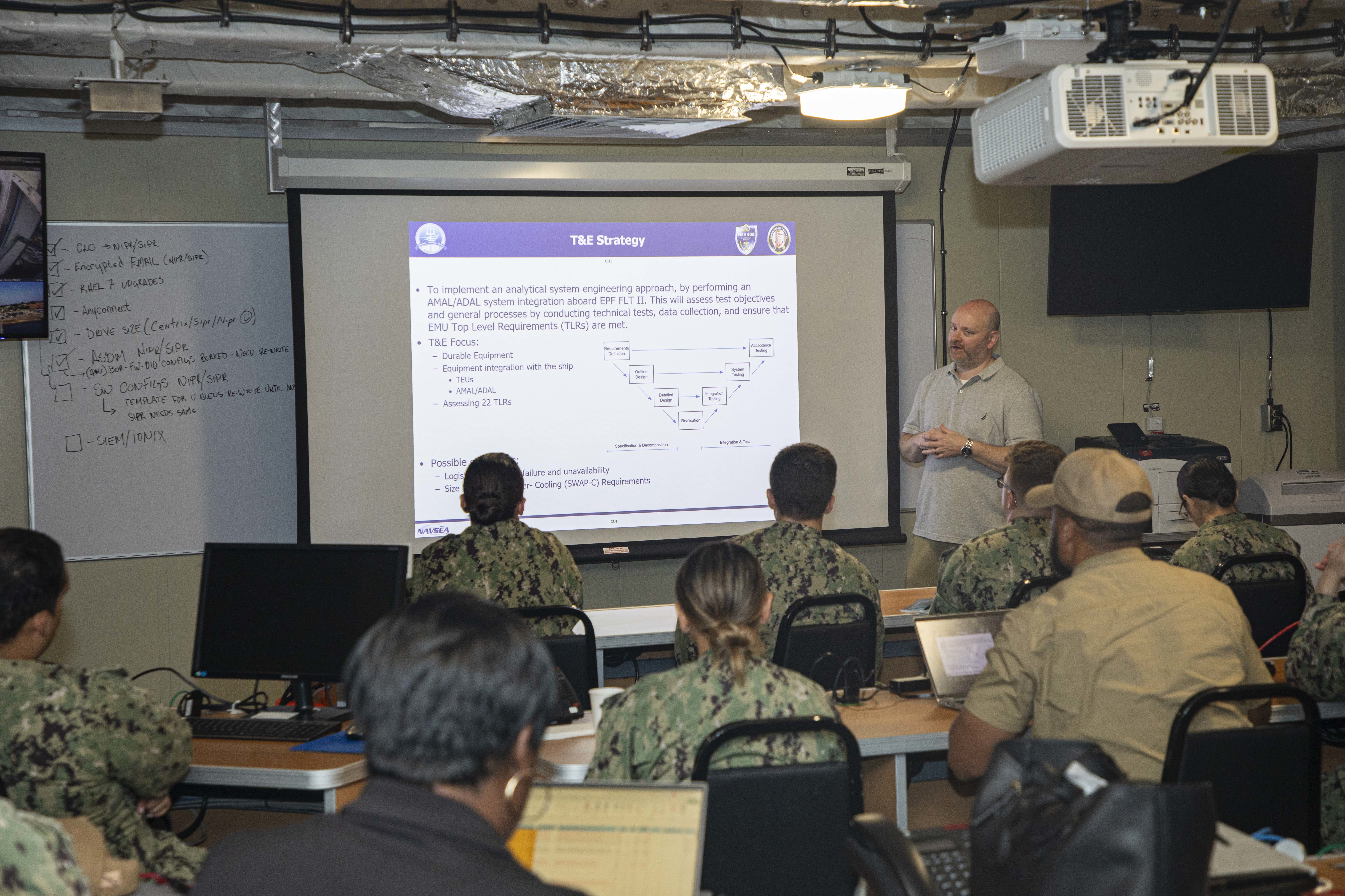 240715-N-KC192-1015 JOINT EXPEDITIONARY BASE LITTLE CREEK-FORT STORY, Va. (July 15, 2024) Darrin Flynn, the training and education director with Military Sealift Command, briefs Expeditionary Medical Unit (EMU) Sailors on training and education strategies onboard expeditionary fast transport ship USNS Cody (T-EPF 14), July 15, 2024. The U.S. Navy is embarking on the first EMU, a cutting-edge medical support system with support personnel from EMU-1, designed to provide Role 2 level healthcare services both afloat and ashore.  (U.S. Navy photo by Mass Communication Specialist 2nd Class Levi Decker)