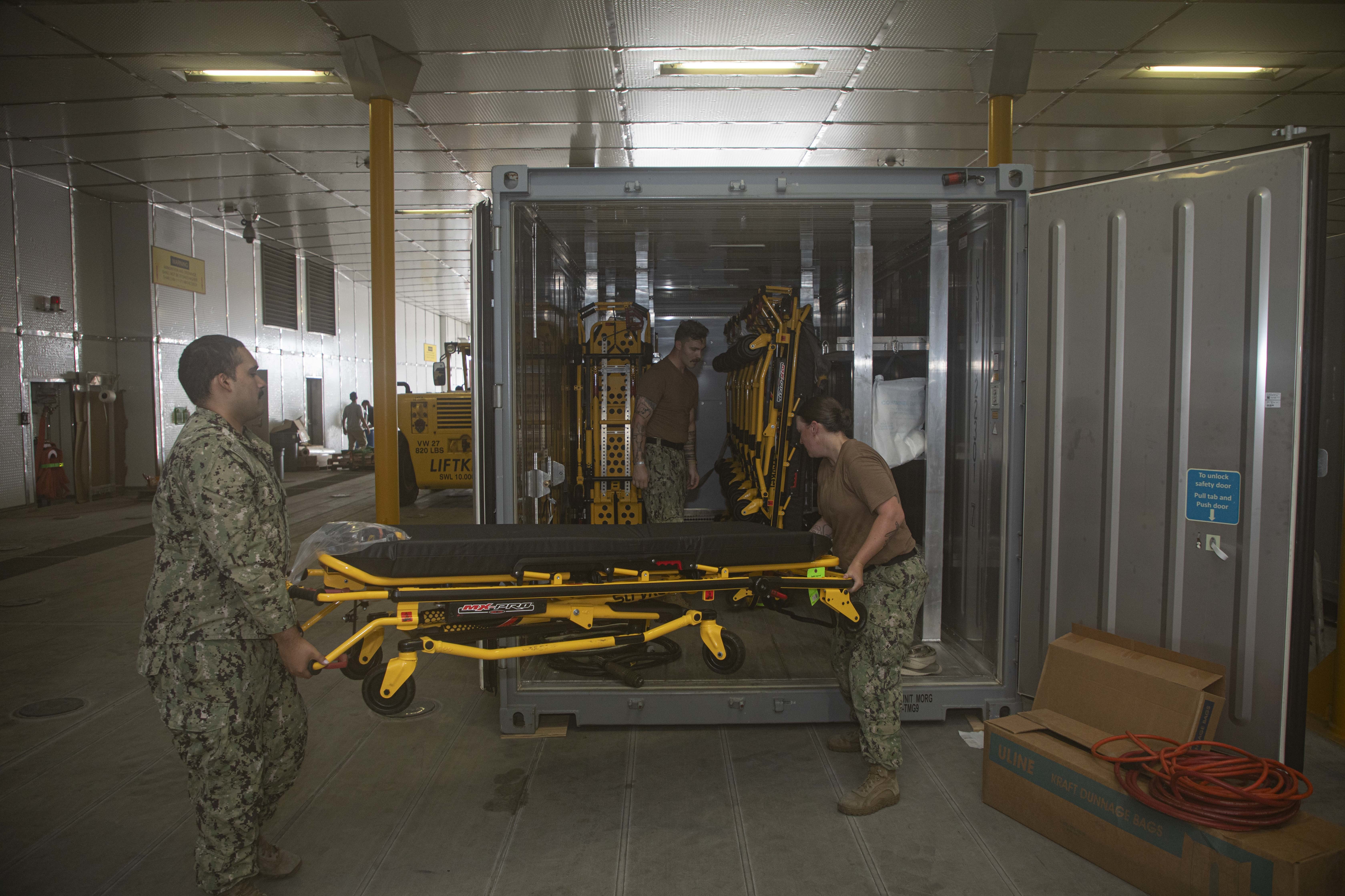 240722-N-KC192-1085 JOINT EXPEDITIONARY BASE LITTLE CREEK-FORT STORY, Va. (July 22, 2024) Sailors assigned to Navy Medicine Readiness and Training Command (NMRTC) Jacksonville, stores a gurney for pack up onboard the transport ship USNS Cody (T-EPF 14), July 22, 2024. The U.S. Navy is embarking the first Expeditionary Medical Unit (EMU), a cutting-edge medical support system with support personnel from EMU-1, designed to provide Role 2 level healthcare services both afloat and ashore.  (U.S. Navy photo by Mass Communication Specialist 2nd Class Levi Decker)