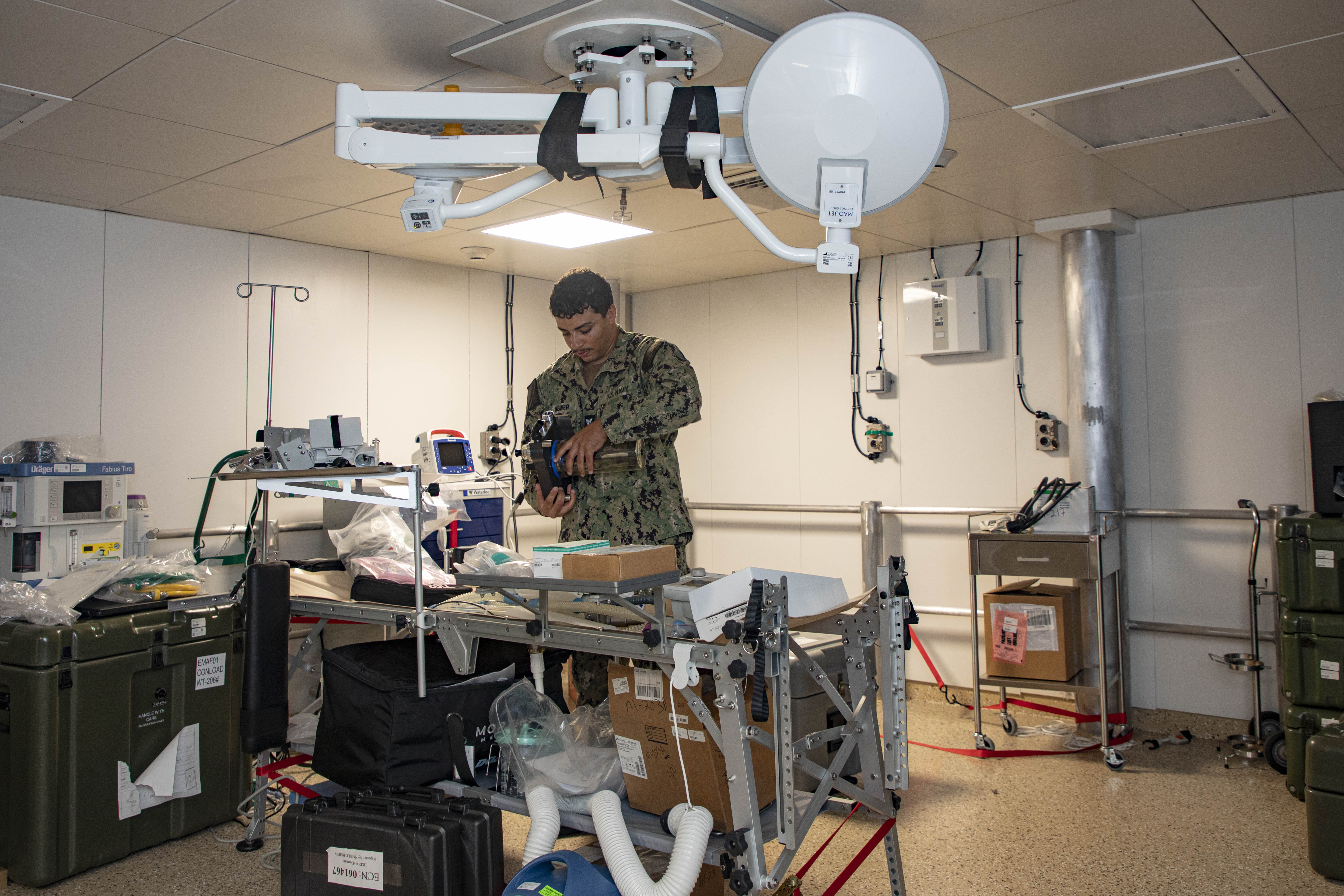 240722-N-KC192-1077 JOINT EXPEDITIONARY BASE LITTLE CREEK-FORT STORY, Va. (July 22, 2024) Hospital Corpsman 3rd Class Wesley Weaver, assigned to Navy Medicine Readiness and Training Command (NMRTC) Jacksonville, disassembles equipment for pack up onboard the transport ship USNS Cody (T-EPF 14), July 22, 2024. The U.S. Navy is embarking the first Expeditionary Medical Unit (EMU), a cutting-edge medical support system with support personnel from EMU-1, designed to provide Role 2 level healthcare services both afloat and ashore.  (U.S. Navy photo by Mass Communication Specialist 2nd Class Levi Decker)