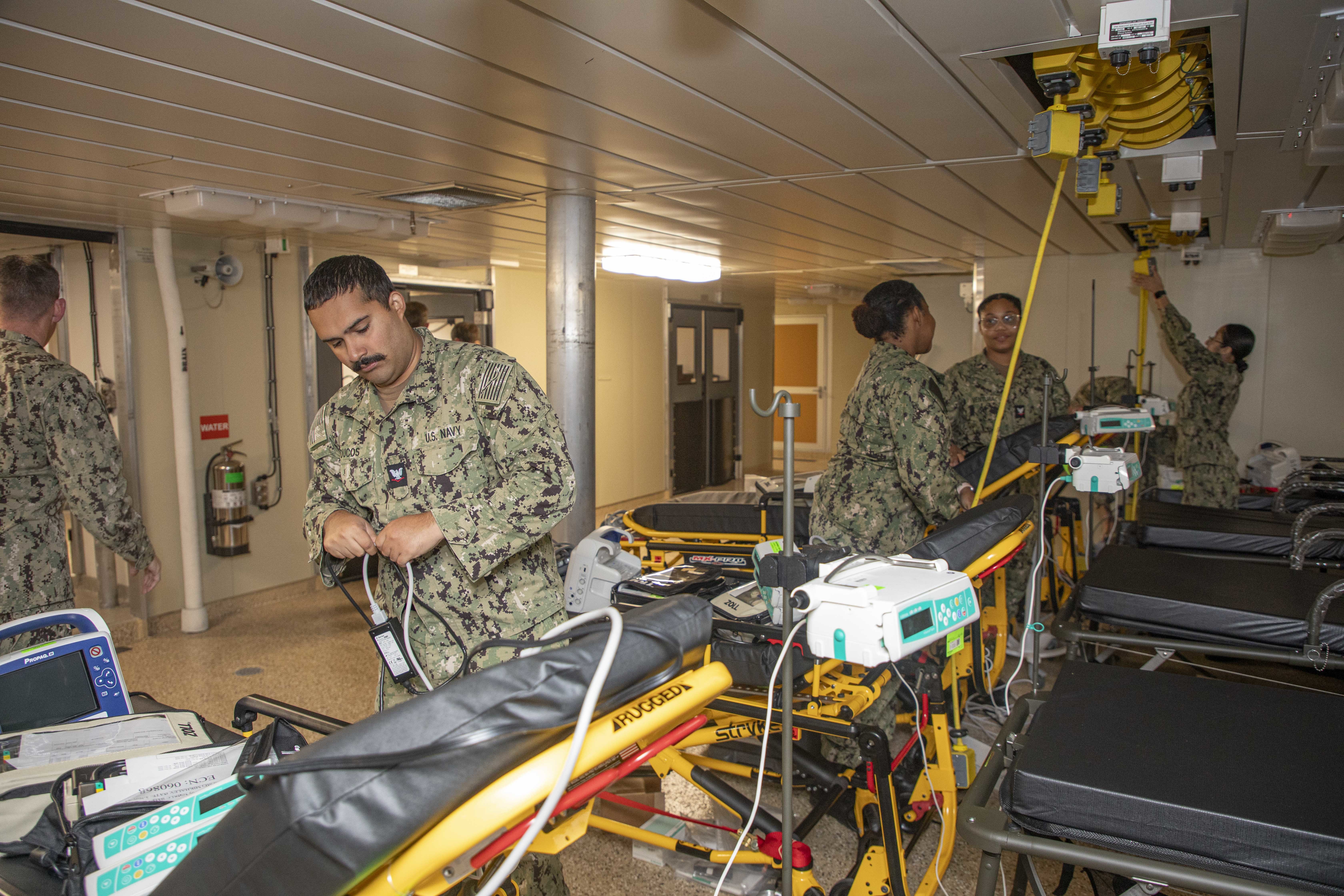 240722-N-KC192-1026 JOINT EXPEDITIONARY BASE LITTLE CREEK-FORT STORY, Va. (July 22, 2024) Hospital Corpsman 3rd Class Ronald Ducos, assigned to Navy Medicine Readiness and Training Command (NMRTC) Jacksonville, disassembles equipment for pack up onboard the transport ship USNS Cody (T-EPF 14), July 22, 2024. The U.S. Navy is embarking the first Expeditionary Medical Unit (EMU), a cutting-edge medical support system with support personnel from EMU-1, designed to provide Role 2 level healthcare services both afloat and ashore.  (U.S. Navy photo by Mass Communication Specialist 2nd Class Levi Decker)