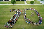 Members of the 637th Training Group and the 37th Training Wing form a “70” in celebration of the Defense Language Institute English Language Center’s 70th Anniversary, at Joint Base San Antonio-Lackland, Texas, July 31, 2024. DLIELC helps build security cooperation capability through English language training and cultural immersion to U.S. and international military and civilians.