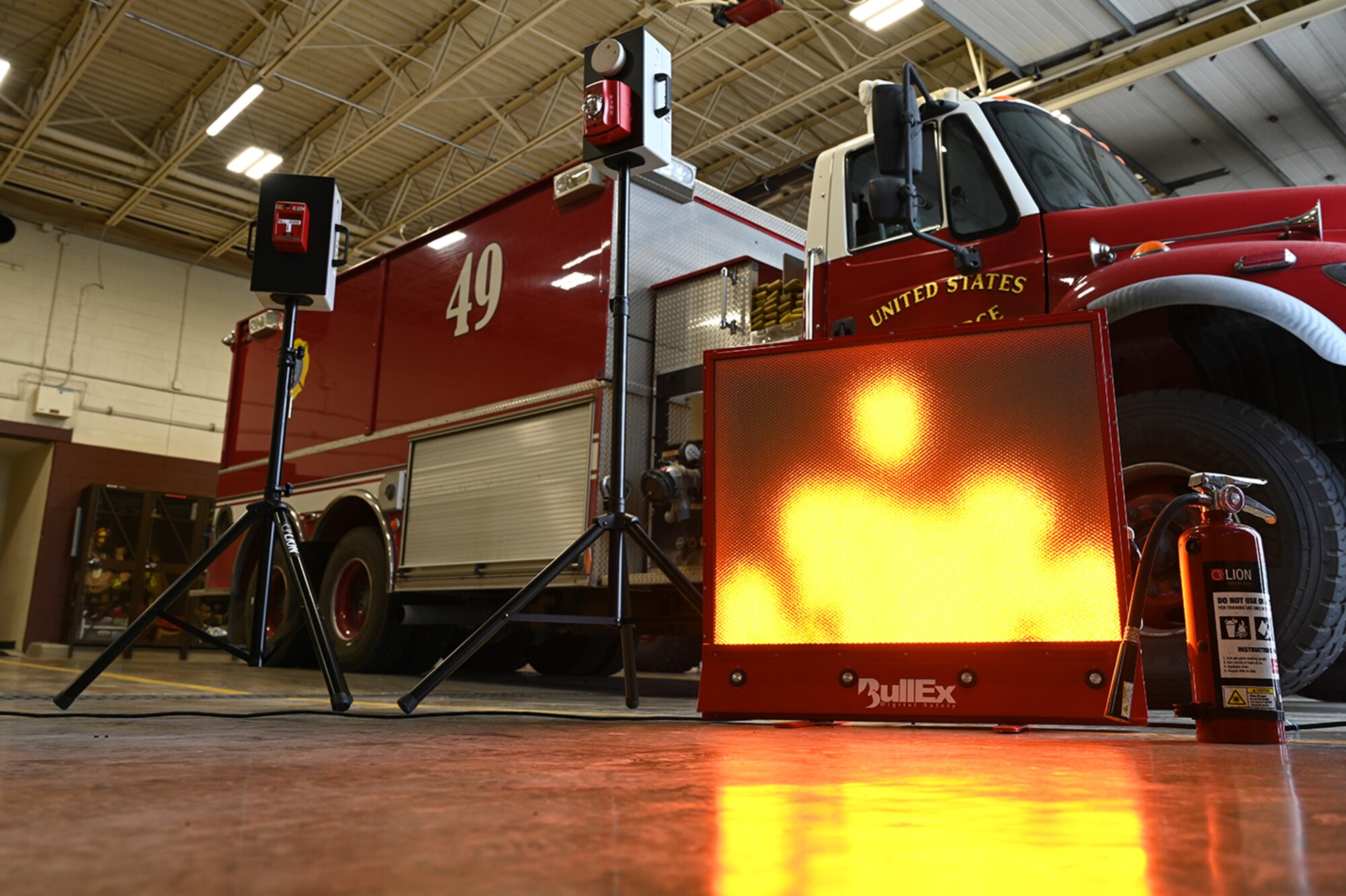 Digital screen on floor next to a fire truck