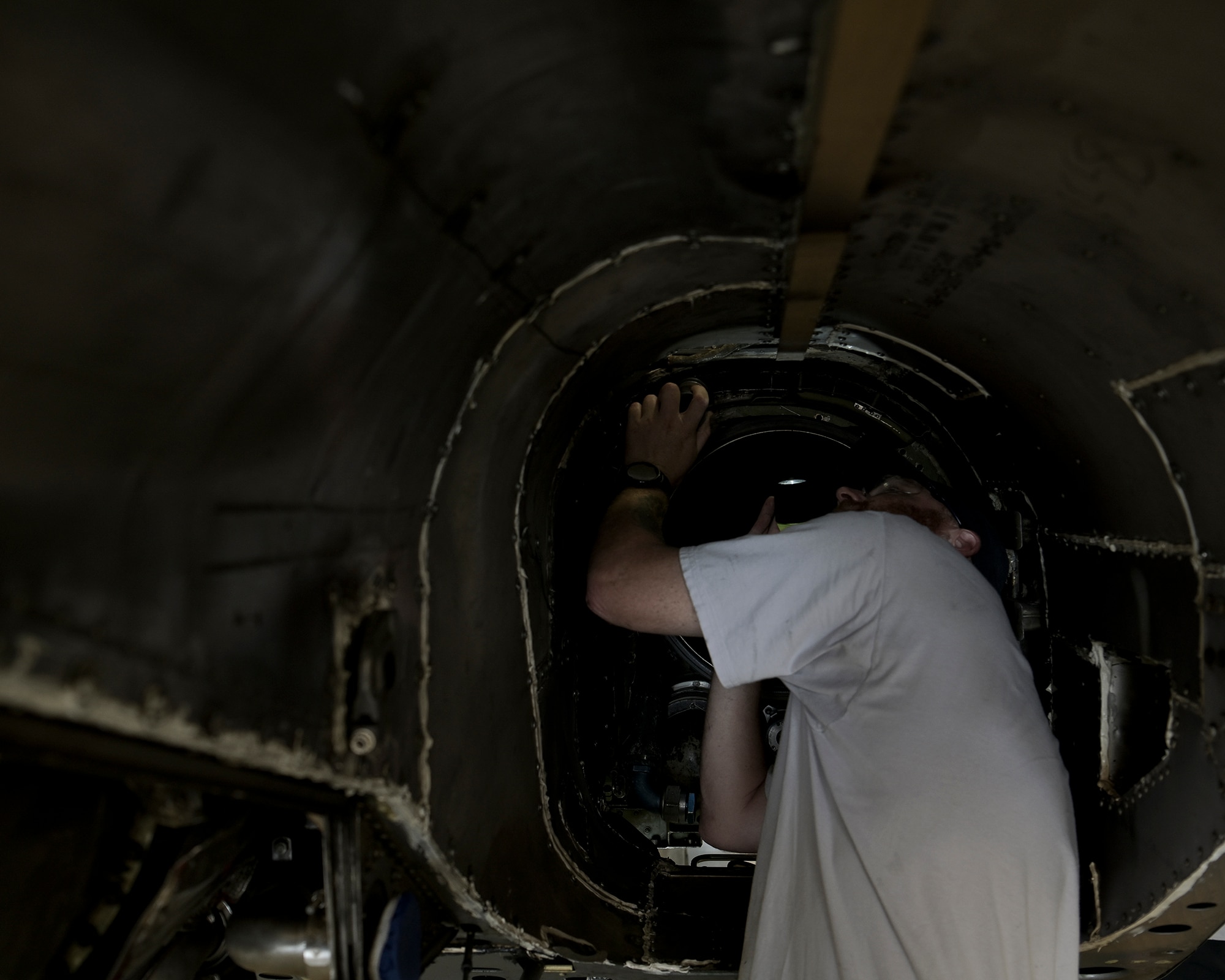 Aircraft maintenance personnel perform maintenance.