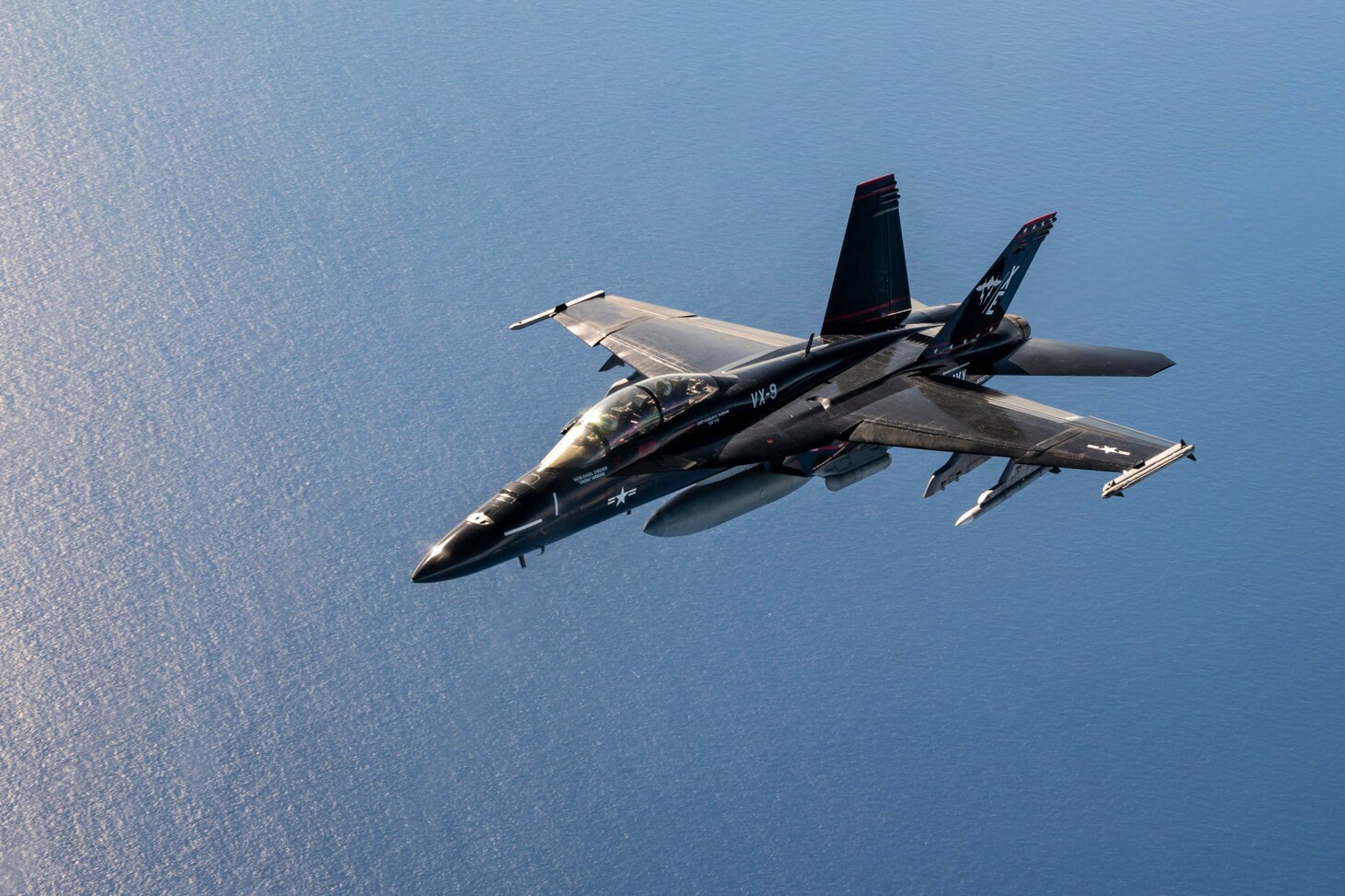 A U.S. Navy FA-18 Super Hornet flies near a U.S. Air Force KC-135 Stratotanker with MacDill Air Force Base, Florida, after being refueled near Joint Base Pearl Harbor-Hickam, Hawaii, during Exercise Rim of the Pacific (RIMPAC) 2024, July 18. Twenty-nine nations, 40 surface ships, three submarines, 14 national land forces, more than 150 aircraft and 25,000 personnel are participating in RIMPAC in and around the Hawaiian Islands, June 27 to Aug. 1. The world’s largest international maritime exercise, RIMPAC provides a unique training opportunity while fostering and sustaining cooperative relationships among participants critical to ensuring the safety of sea lanes and security on the world’s oceans. RIMPAC 24 is the 29th exercise in the series that began in 1971. (U.S. Air Force photo by Staff Sgt. Tiffany A. Emery)