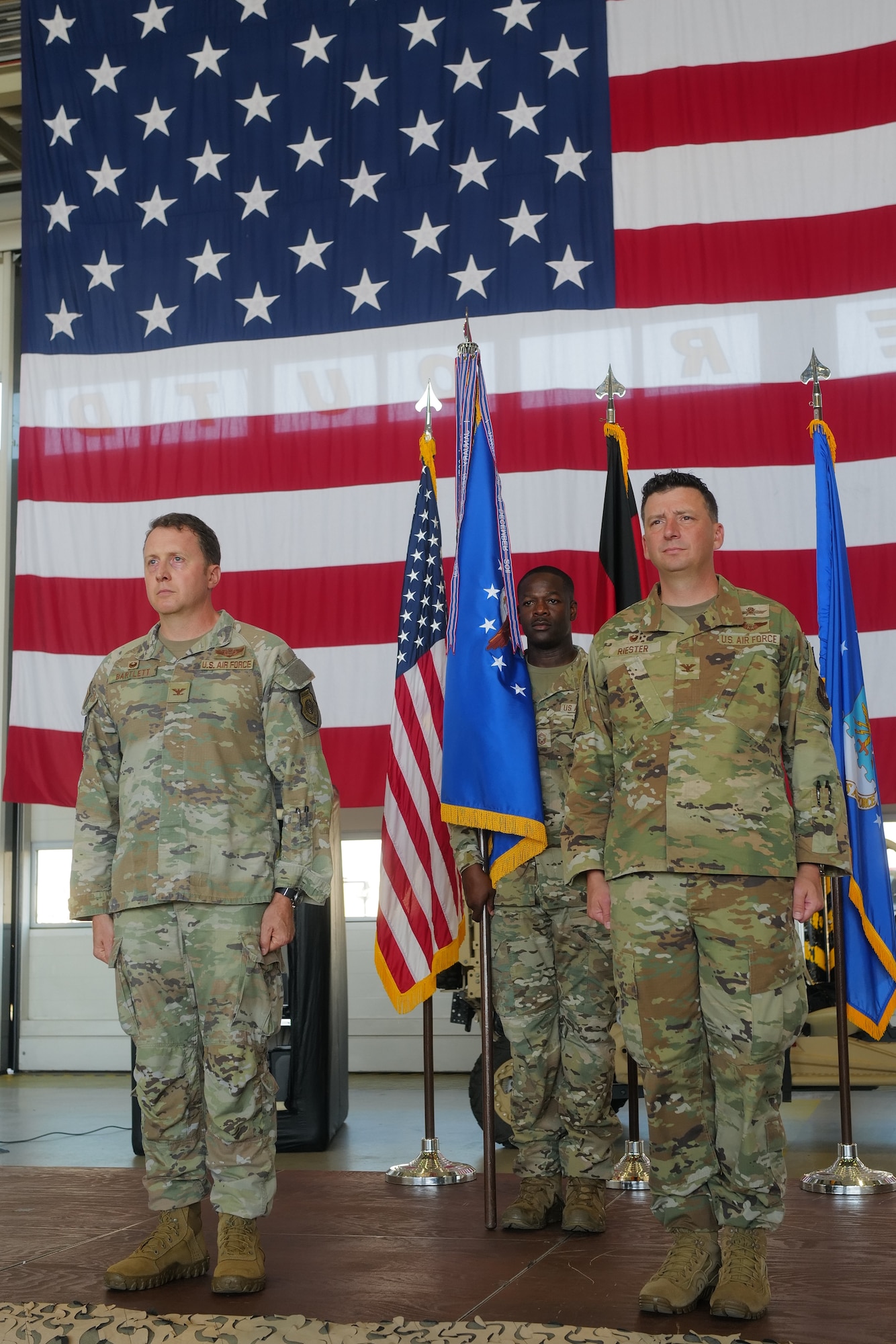 Members take part in change of designation ceremony.