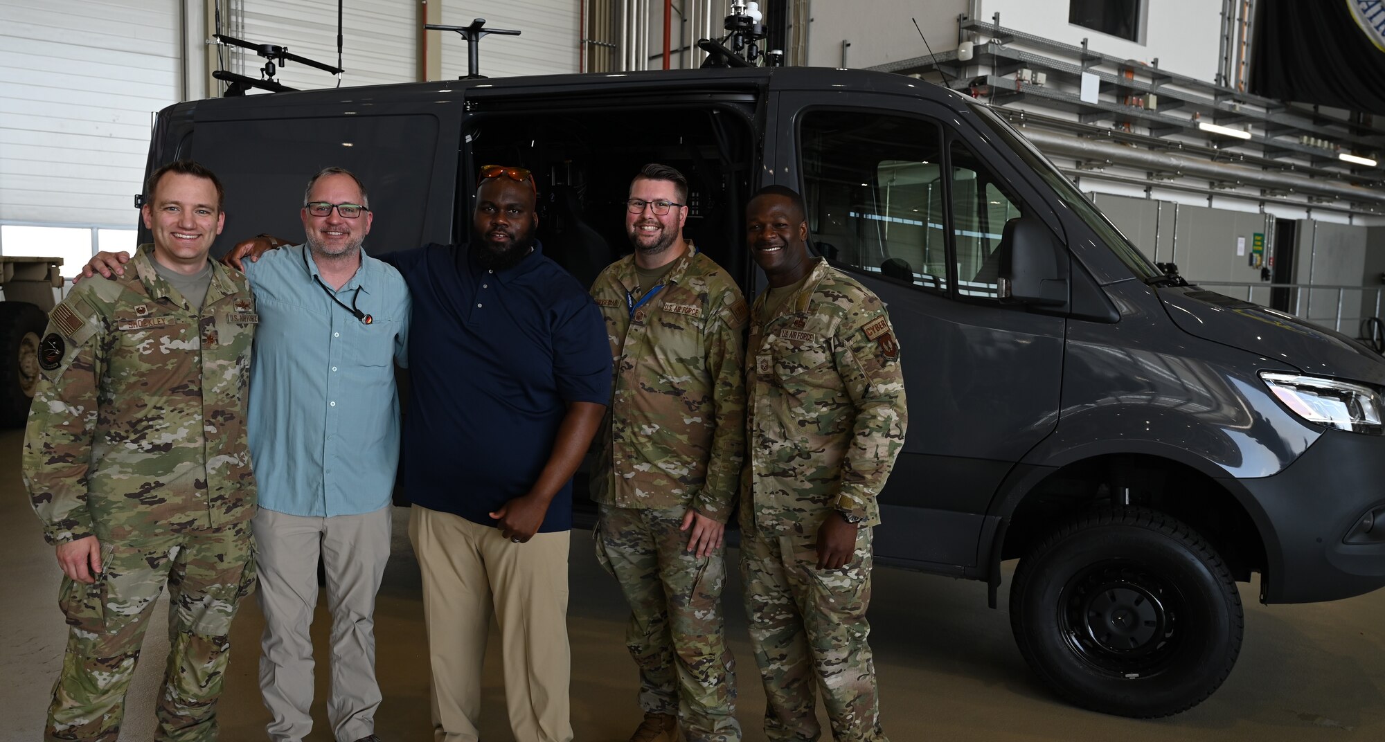 Members of the 435th COG stand in front of a mobile digital infrastructure vehicle.