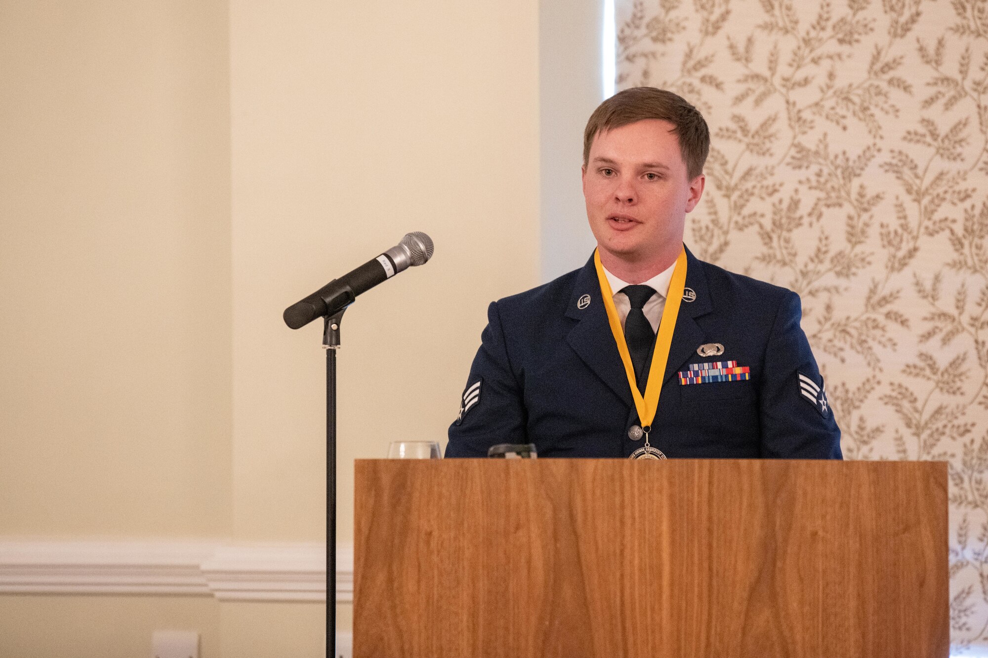 Airman gives remarks during an ALS graduation ceremony