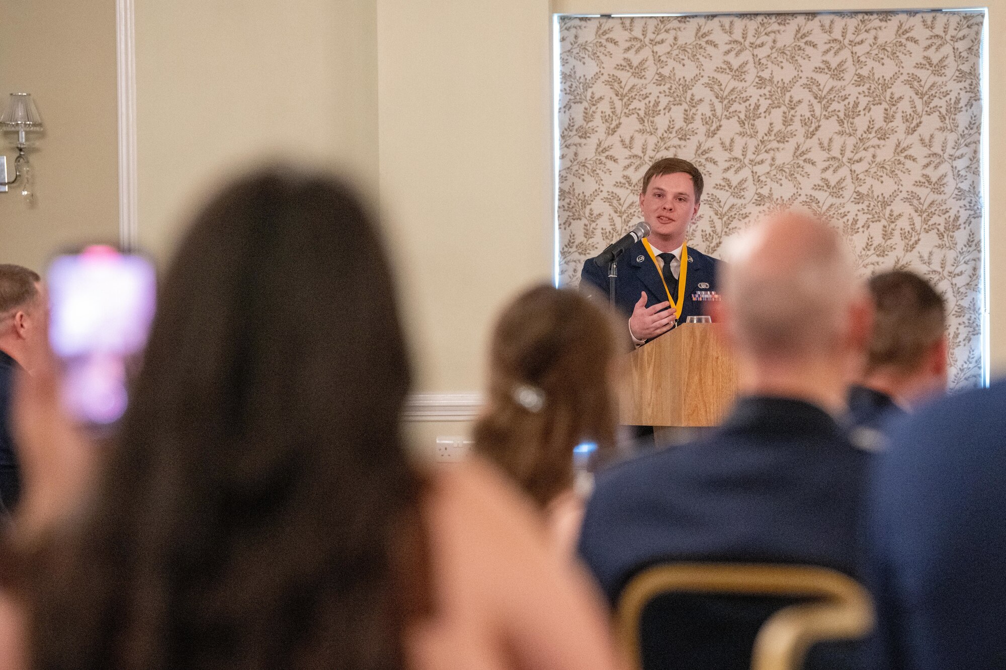 Airman gives remarks during an ALS graduation ceremony