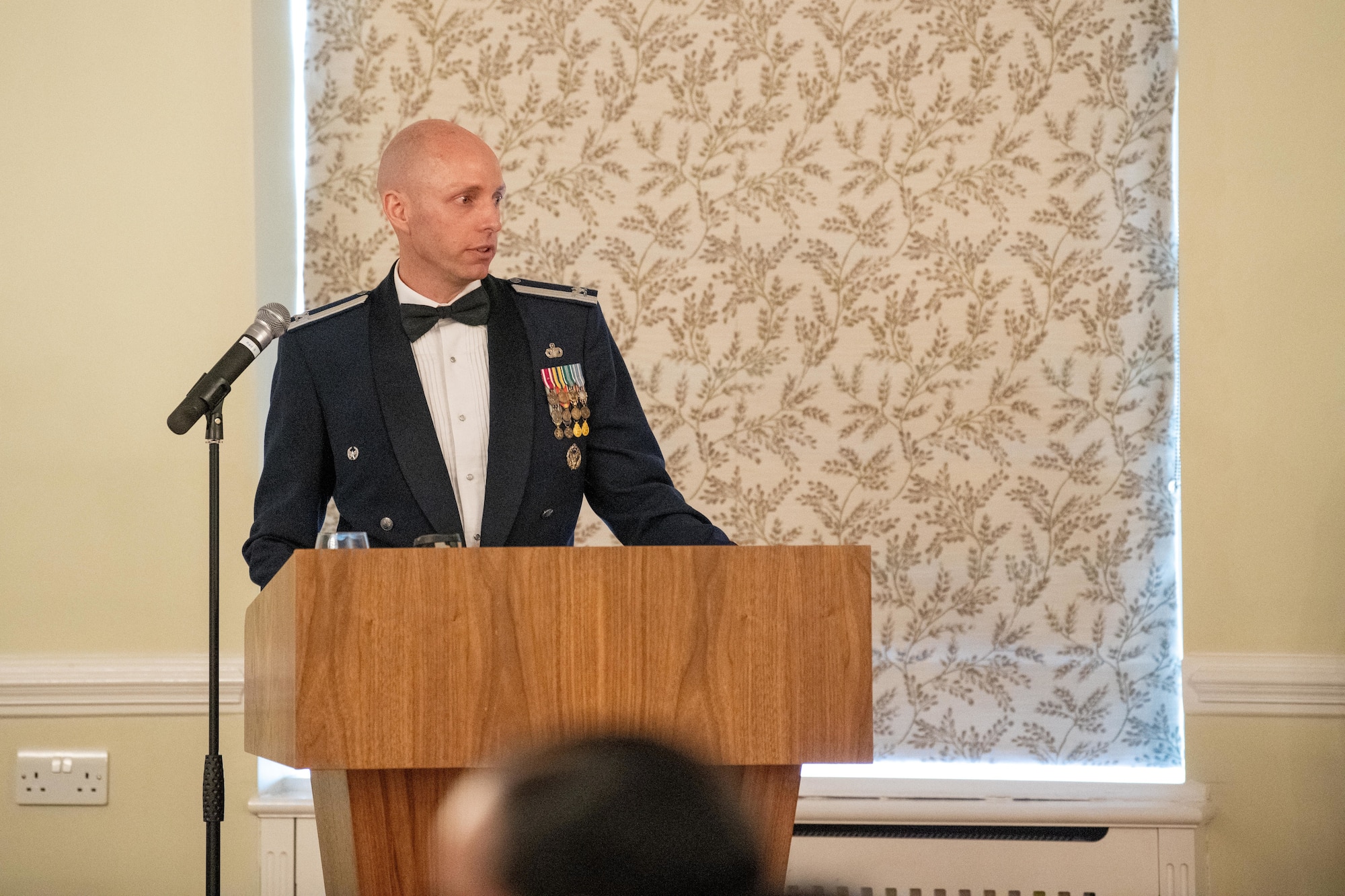 Airman gives remarks during an ALS graduation ceremony