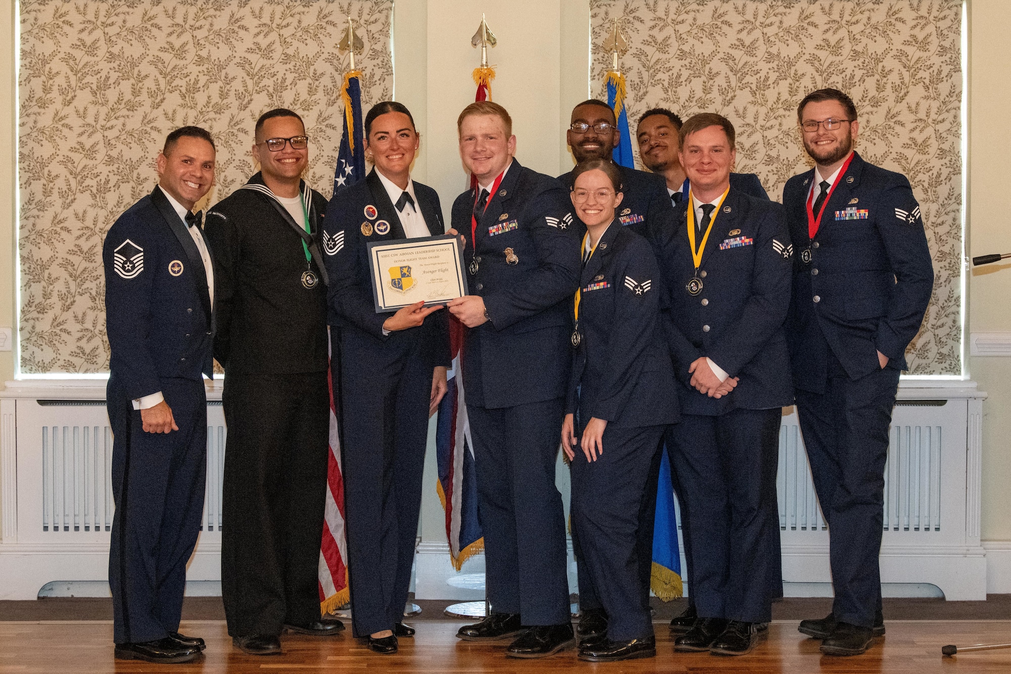 Members of ‘Avenger Flight’ receive the Honor Flight Team Award during an ALS graduation ceremony