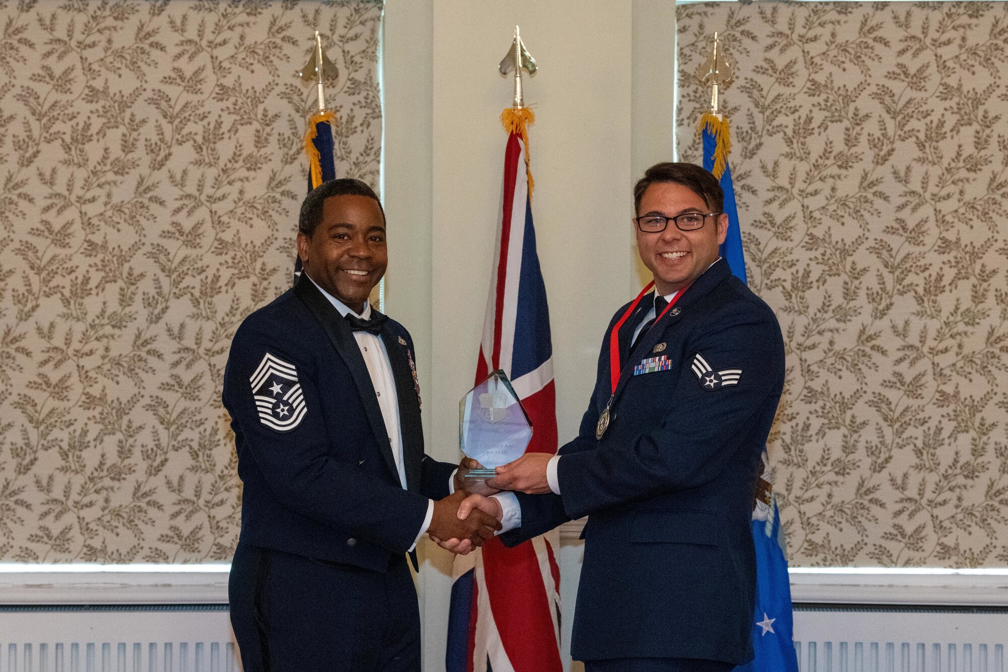 Airman receives the distinguished graduate award during an Airman Leadership School graduation ceremony