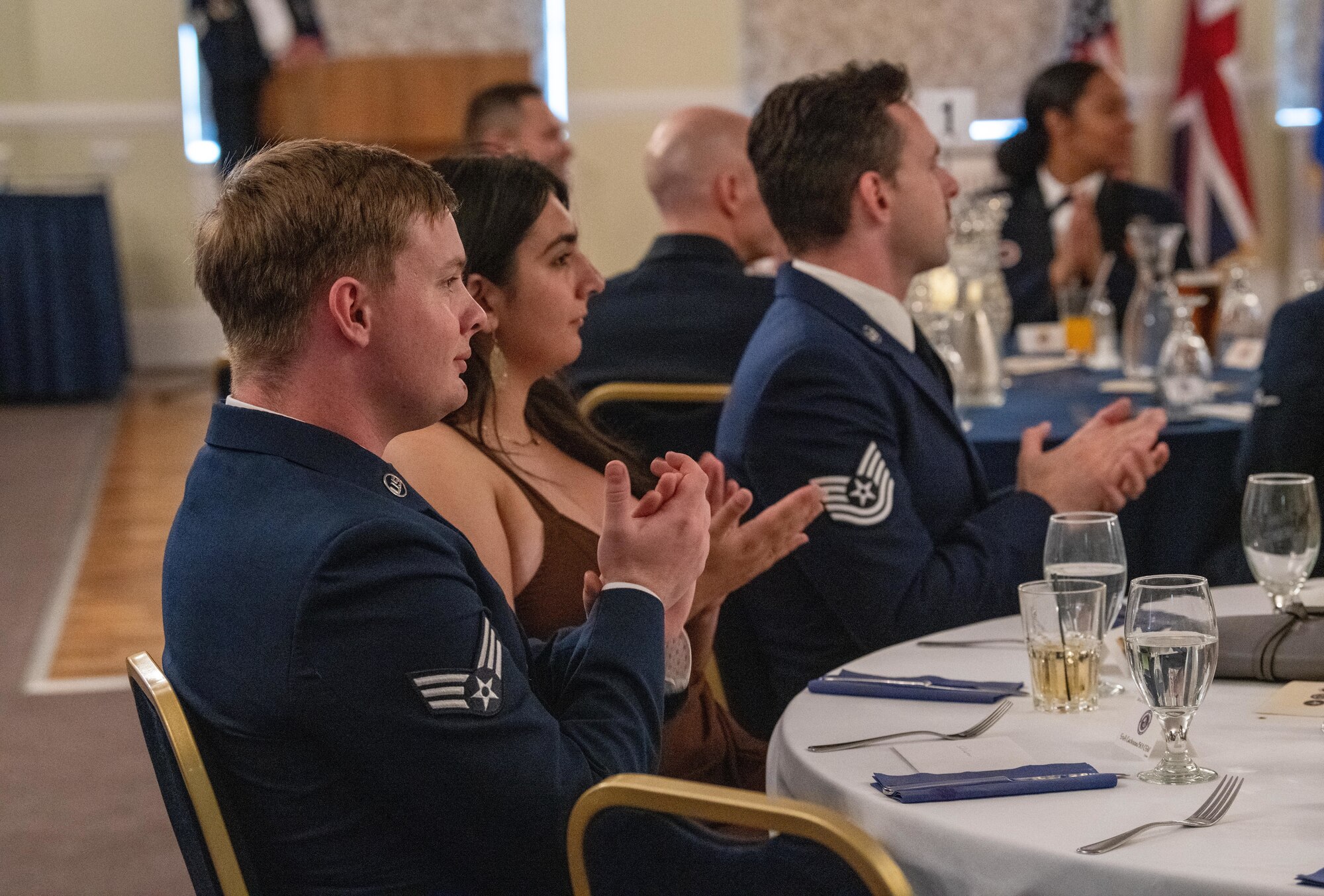 Attendees applaud during an Airman Leadership School graduation ceremony