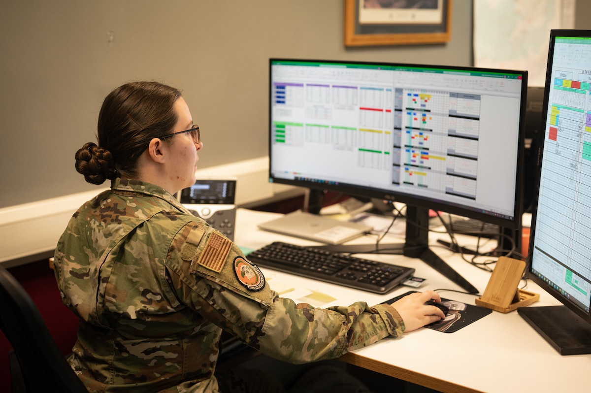U.S. Air Force member sets up a schedule on a computer.