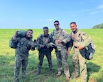 Lt. Col. Denny Frey, Special Operations Detachment - Pacific, with Malaysian counterparts following their first successful jump during LEAPFEST 2024 in Rhode Island Aug. 2, 2024.