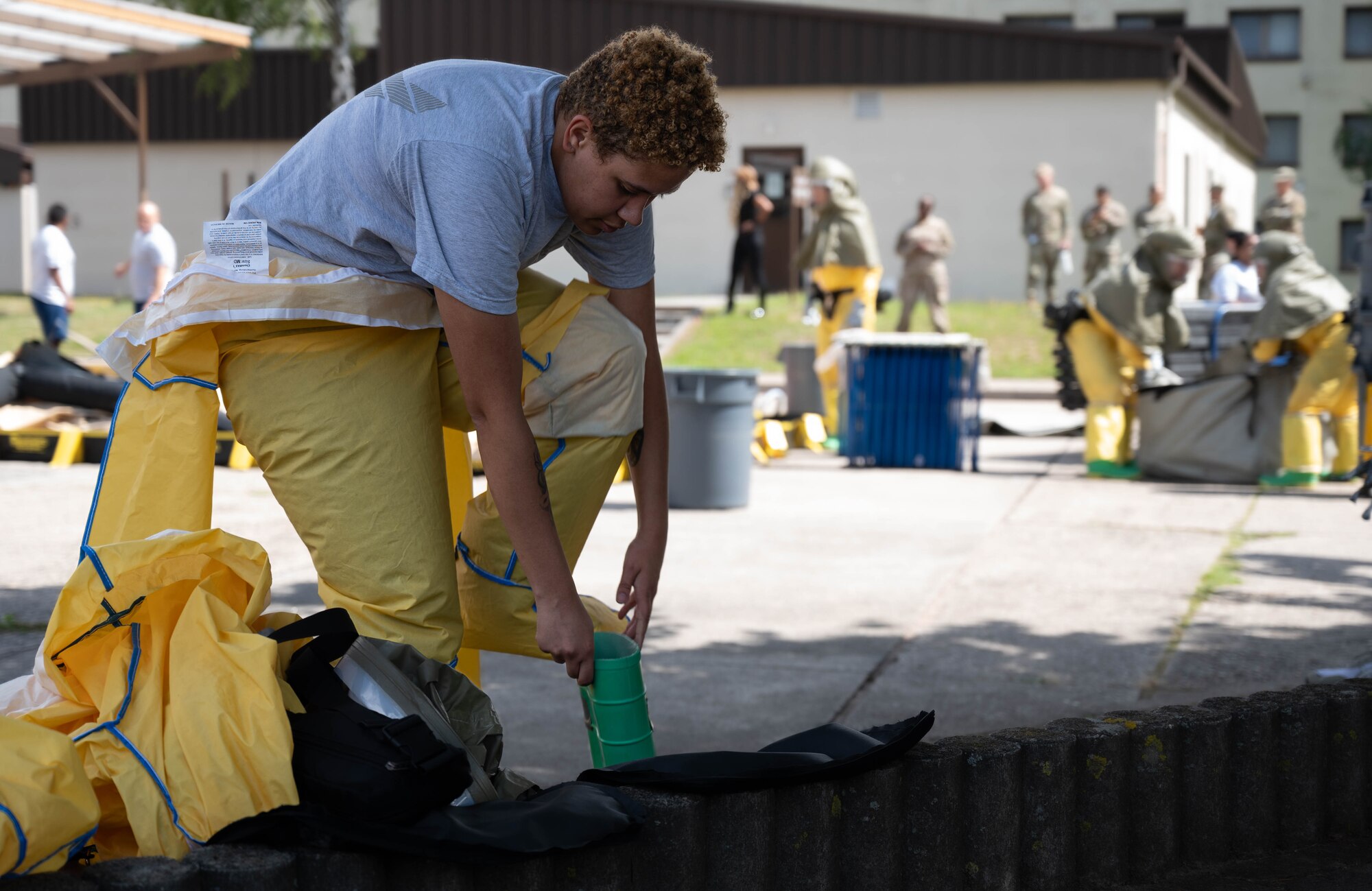 U.S. Air Force Staff Sgt. Marissa Cyphers, 86th Operational Medical Readiness Squadron noncommissioned officer in charge of warrior medicine, dawns her powered air purifying respirator during the 86th Medical Group’s in-place patient decontamination training capstone at Ramstein Air Base, Germany, Aug. 8, 2024. Airmen simulated being in a situation where they had to set up a decontamination tent and decontaminate a patient who had been exposed to a chemical agent. (U.S. Air Force photo by Senior Airman Jared Lovett)