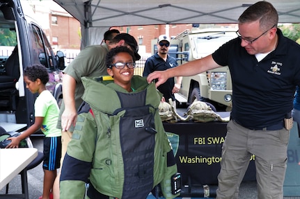 The District of Columbia National Guard Counterdrug Program participated in the Metropolitan Police Department's 41st annual National Night Out celebrations in Southeast Washington, D.C., August 6, 2024. The community-building campaign occurs the first Tuesday of August each year and is held by law enforcement agencies across the country. (U.S. Army National Guard photo by Ayan Sheikh)