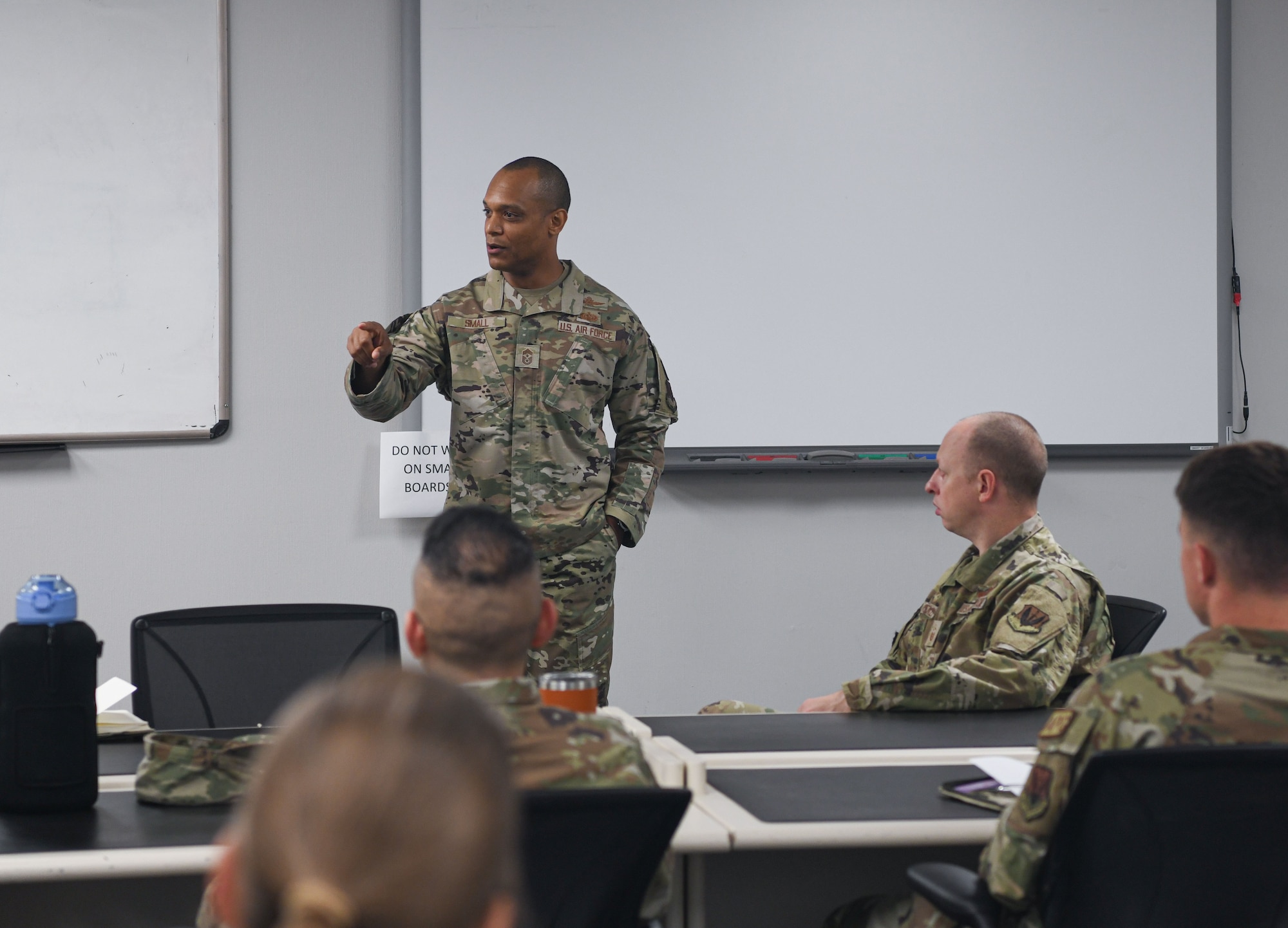 Chief Small speaking to AF students in a classroom.