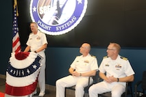 Vice Adm. Johnny R. Wolfe Jr., director of U.S. Navy Strategic Systems Programs (SSP) speaks at a change of command for SSP’s Project Management Office for Flight Systems (SPF) Thursday. Commanding Officer Capt. Michael Woehrman (sitting right) was relieved by Cmdr. Christopher Tilley (sitting left), the former Weapons Officer at Strategic Weapons Facility Pacific, during the ceremony which marks longstanding tradition of passing leadership responsibilities in the Navy. Vice Adm. Wolfe lauded the critical work SPF has done to guarantee the success of the Nation's strategic deterrent as an underwriter for the safety of all Americans and reassurance to our allies, worldwide.  SPF—one of SSP’s many field sites—provides the technical oversight and fleet support for the nation's sea-based strategic deterrent and equip the nation’s Warfighting Navy with safe, secure, reliable, and effective weapon systems (U.S. Navy Photo by Yeoman Submarine 2nd Class Alakai Merino/Released).