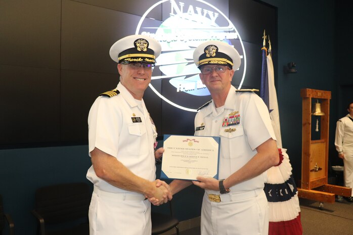 Vice Adm. Johnny R. Wolfe Jr., director of U.S. Navy Strategic Systems Programs (SSP) (left) congratulates outgoing Commanding Officer Capt. Michael Woehrman (right) during a change of command for SSP’s Project Management Office for Flight Systems (SPF) Thursday. Capt. Woehrman was relieved by Cmdr. Christopher Tilley, the former Weapons Officer at Strategic Weapons Facility Pacific, during the ceremony which marks longstanding tradition of passing leadership responsibilities in the Navy. Vice Adm. Wolfe praised Capt. Woehrman's leadership which ensured growth and development of the workforce; improvements to infrastructure and capabilities; and oversaw multiple critical operation tests for the strategic weapon systems, ensuring submarine and sailor warfighting readiness. 20SPF—one of SSP’s many field sites—provides the technical oversight and fleet support for the nation's sea-based strategic deterrent and equip the nation’s Warfighting Navy with safe, secure, reliable, and effective weapon systems (U.S. Navy Photo by Yeoman Submarine 2nd Class Alakai Merino/Released).