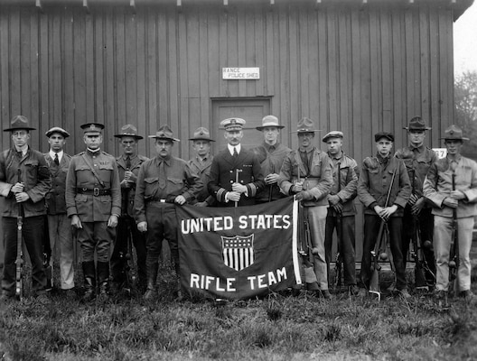 A row of men standing in front of a building.