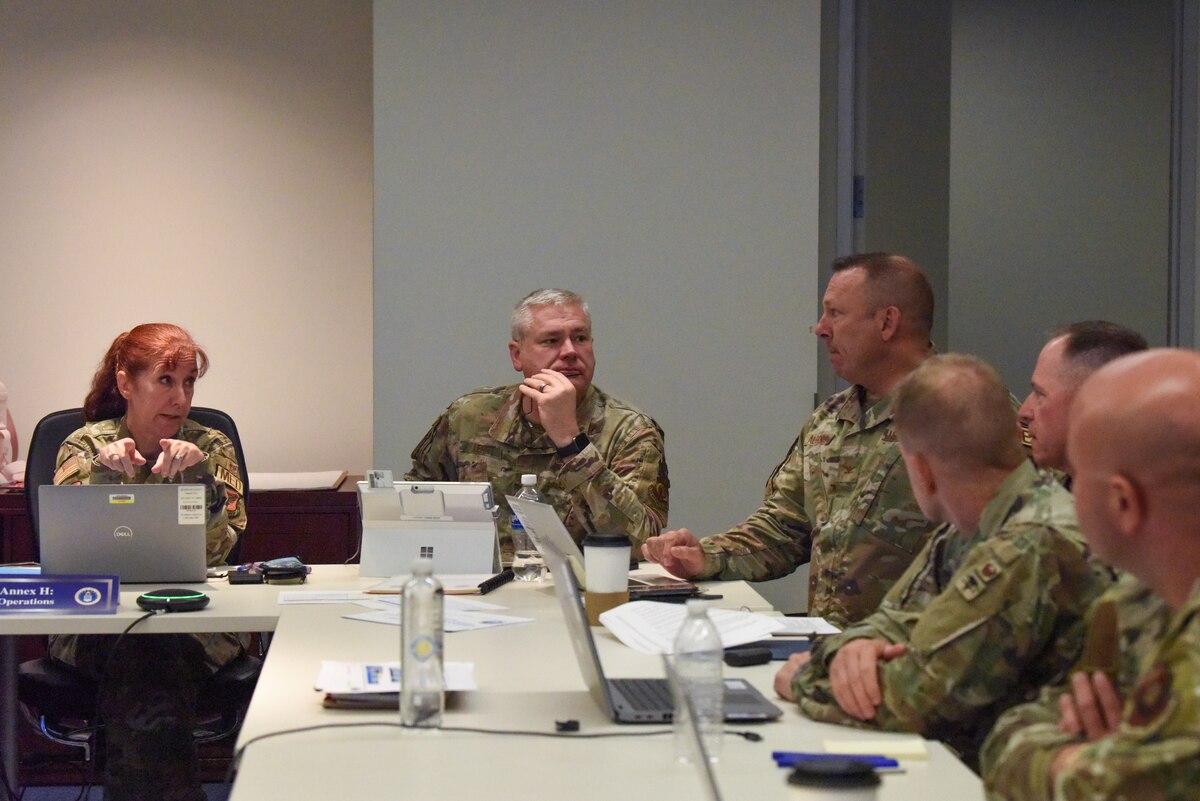 Image of Airmen attending and talking at a meeting