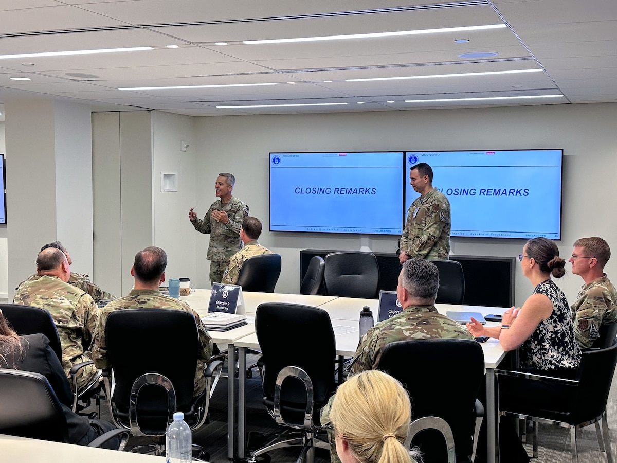 Image of Airmen attending and talking at a meeting.
