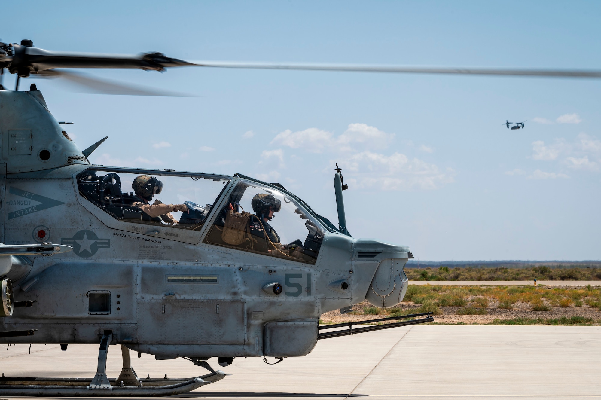U.S. Marine Corps Bell AH-1Z Viper helicopter pilots from the Marine Light Attack Helicopter Squadron 267 prepare for take off at Holloman Air Force Base, New Mexico, July 15, 2024. The HMLA-267 and VMM-364 squadrons, equipped with the Bell UH-1Y Venom and MV-22B Osprey, visited the 6th Attack Squadron to evaluate the MQ-9 Reaper advanced systems and showcase their aircraft adaptability for potential multi-mission scenarios. (U.S. Air Force photo by Senior Airman Isaiah Pedrazzini)