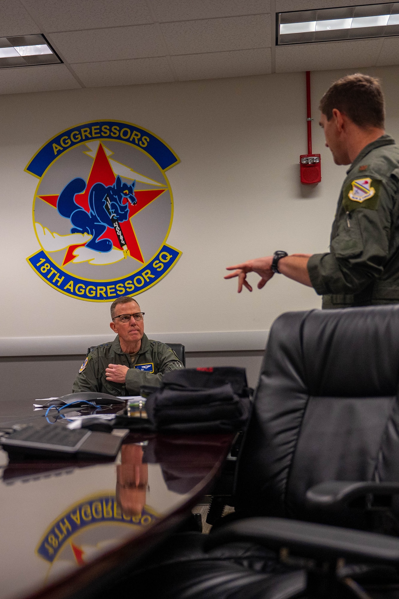 General Gregory Guillot, Commander, North American Aerospace Defense Command and U.S. Northern Command, receives a pre-flight brief from Maj. Daniel Rule, 18th Fighter Interceptor Squadron F-16 Fighting Falcon pilot, at Eielson Air Force Base, Alaska, Aug. 8, 2024.