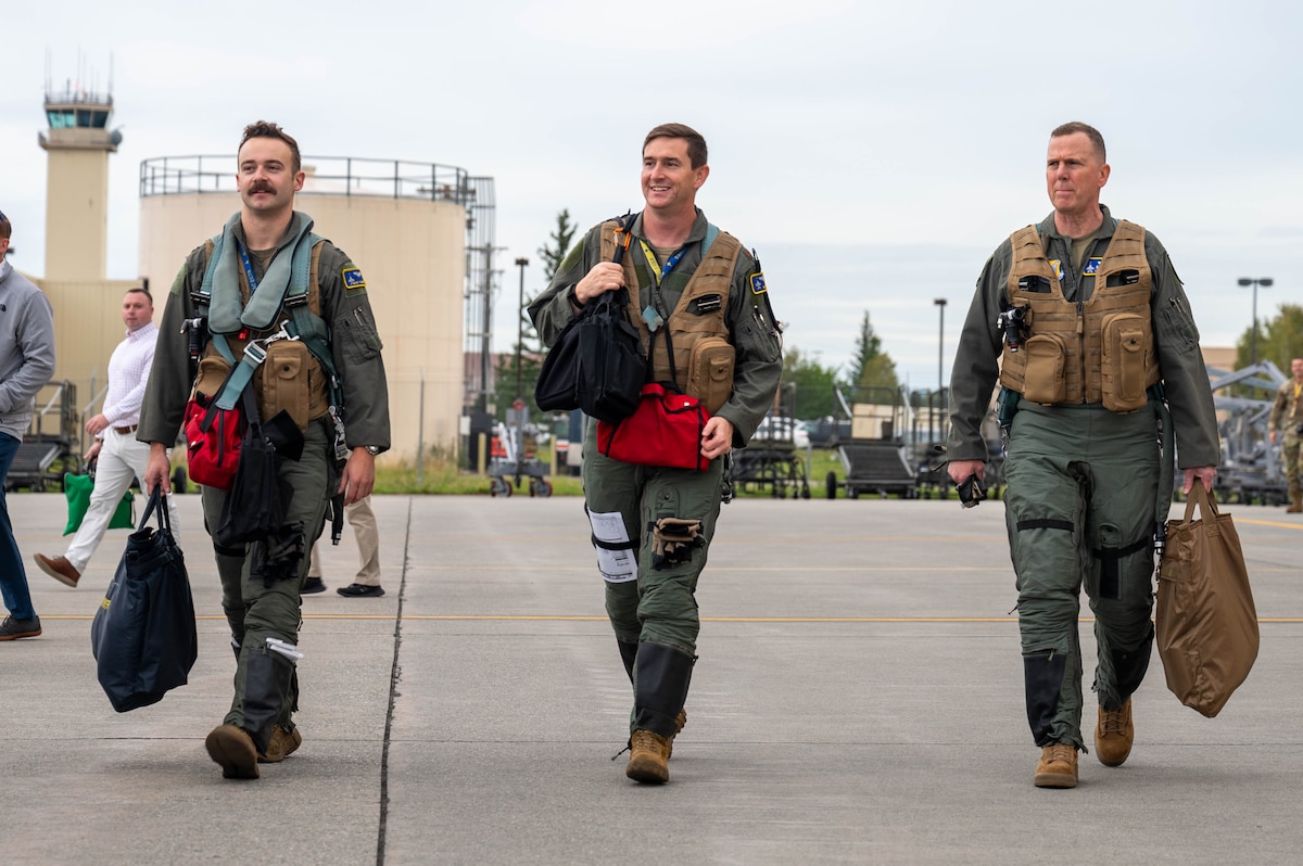 U.S. Air Force Gen. Gregory Guillot (right), Commander, North American Aerospace Defense Command and U.S. Northern Command, and two F-16 Fighting Falcon pilots walk to their aircraft, at Eielson Air Force Base, Alaska, Aug. 8, 2024.