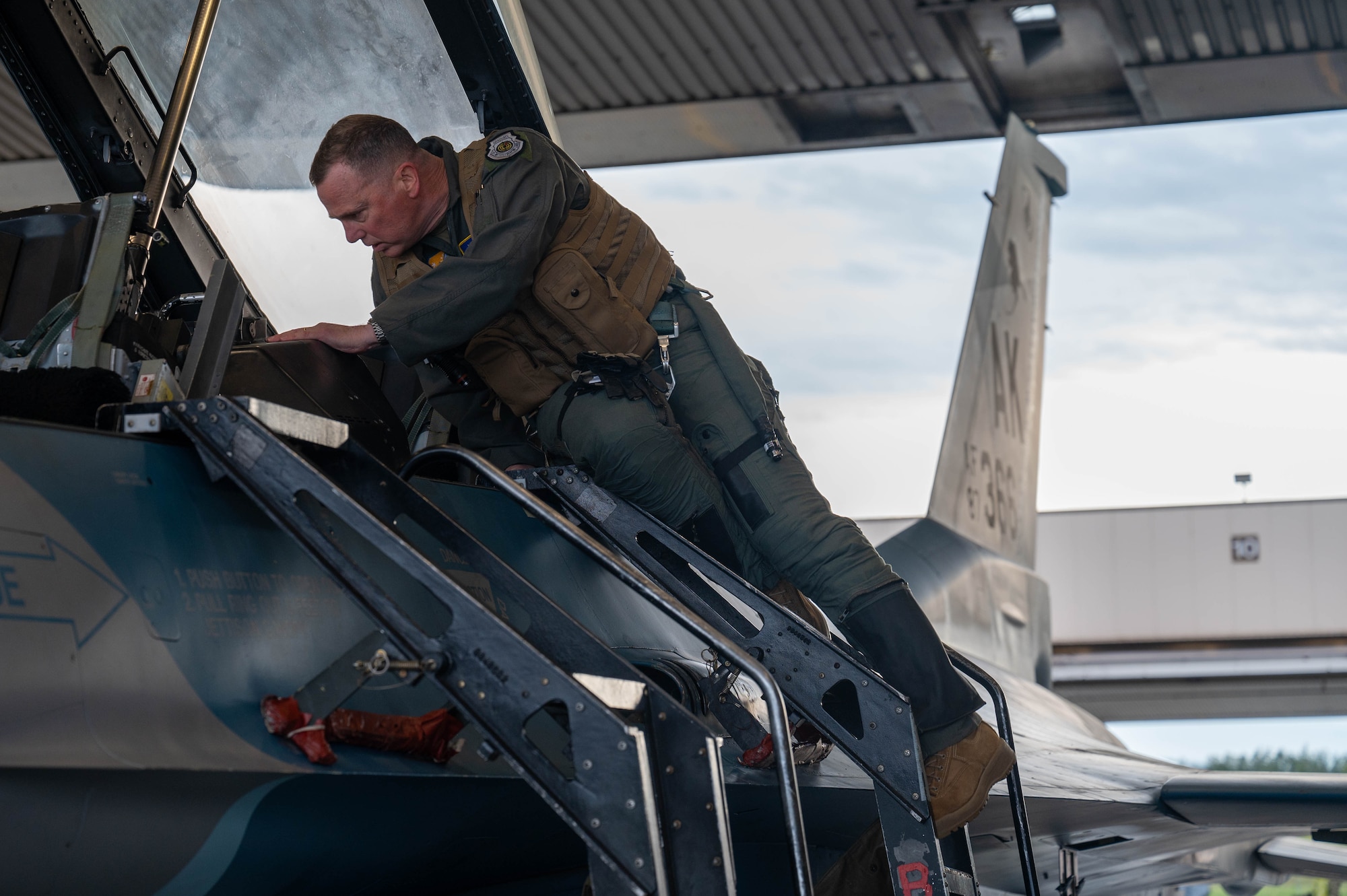 General Gregory Guillot, Commander, North American Aerospace Defense Command and U.S. Northern Command, climbs into the back seat of an F-16 Fighting Falcon, assigned to the 18th Fighter Interceptor Squadron, at Eielson Air Force Base, Alaska, Aug. 8, 2024.