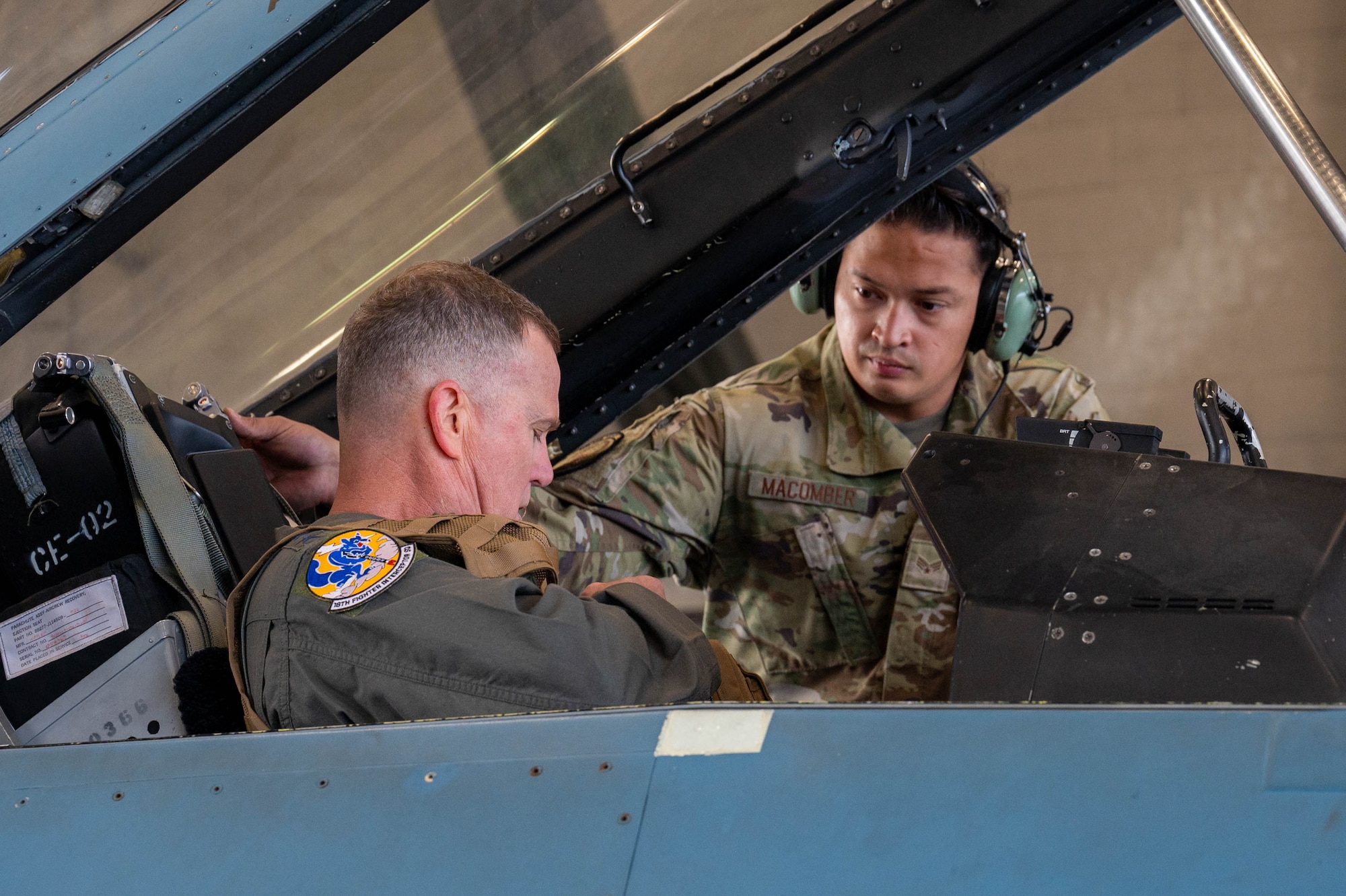 Senior Airman Daniel Macomber, 18th Fighter Generation Squadron dedicated crew chief, assists Gen. Gregory Guillot, Commander, North American Aerospace Defense Command and U.S. Northern Command, as he straps into the back seat of an F-16 Fighting Falcon assigned to the 18th Fighter Interceptor Squadron, at Eielson Air Force Base, Alaska, Aug. 8, 2024.