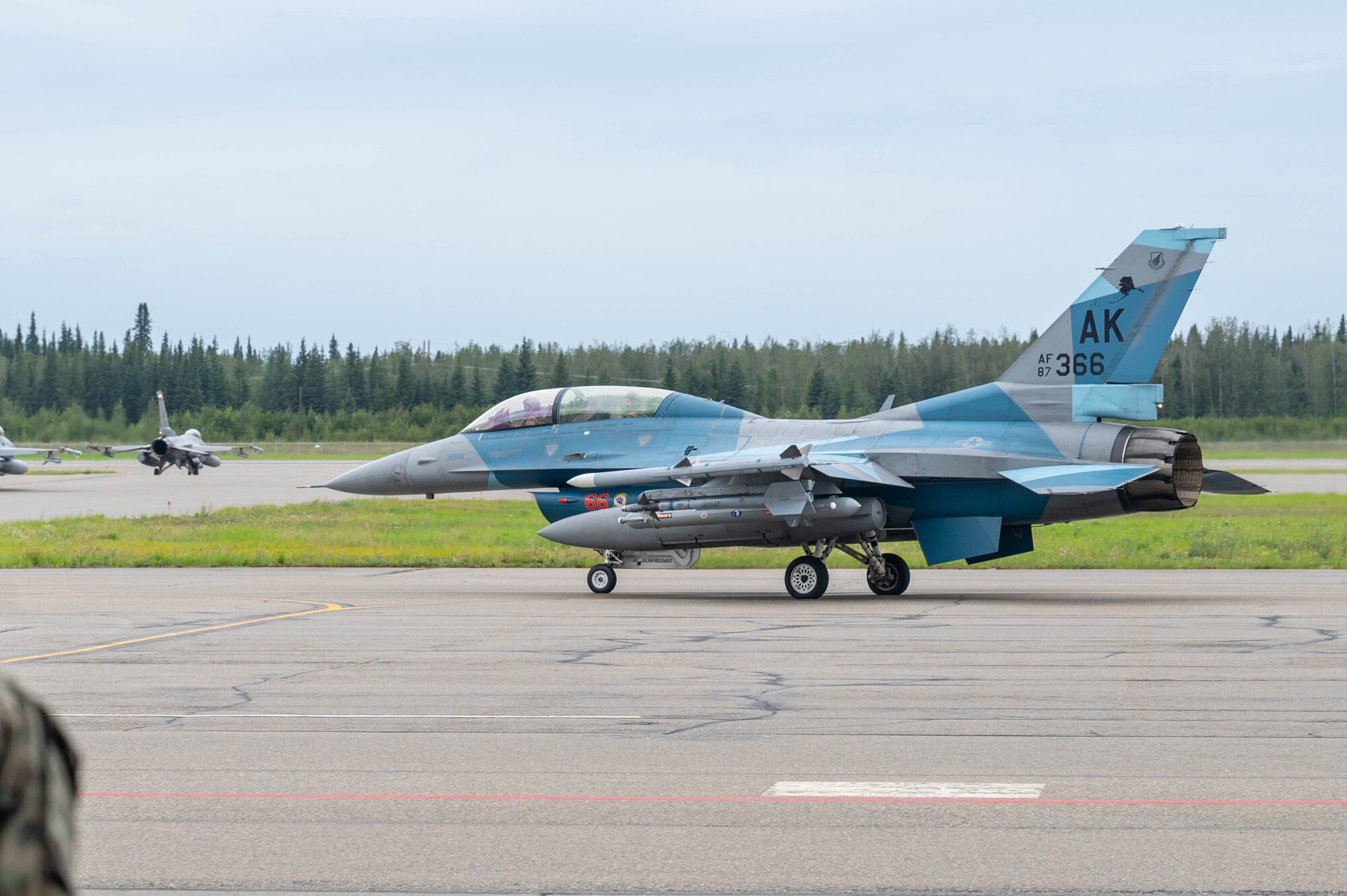 Maj. Daniel Rule, 18th Fighter Interceptor Squadron F-16 Fighting Falcon pilot, and Gen. Gregory Guillot, Commander, North American Aerospace Defense Command and U.S. Northern Command, taxi on the flightline in an F-16, at Eielson Air Force Base, Alaska, Aug. 8, 2024.
