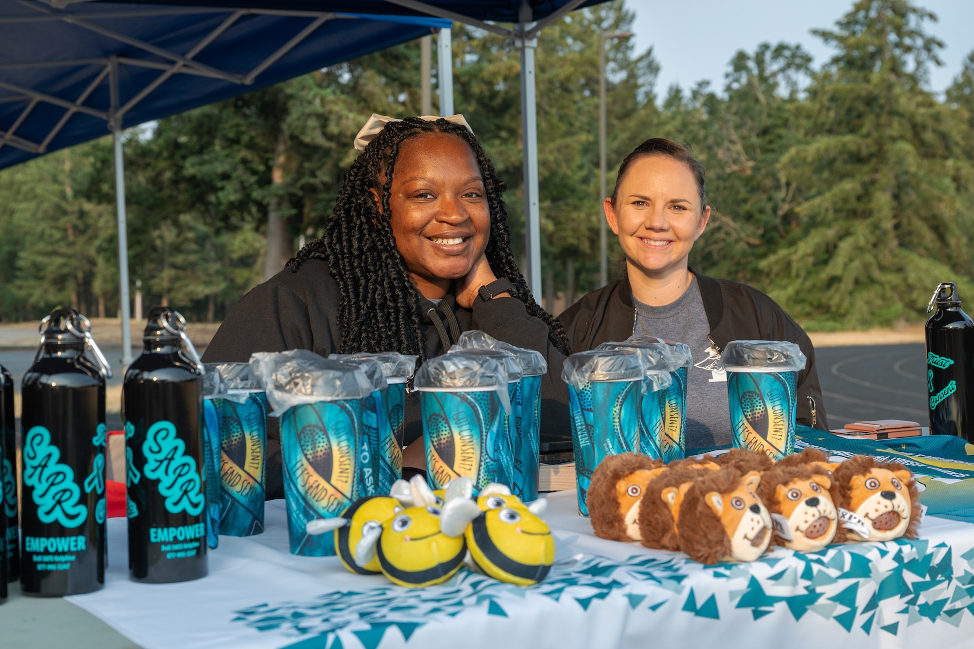 Ashley Jordan, left, and Samantha Robertson, 62d Airlift Wing Sexual Assault Prevention and Response victim advocates, promote resources and services that the 62d AW SAPR office provides at Joint Base Lewis-McChord, Washington, Aug. 9, 2024.