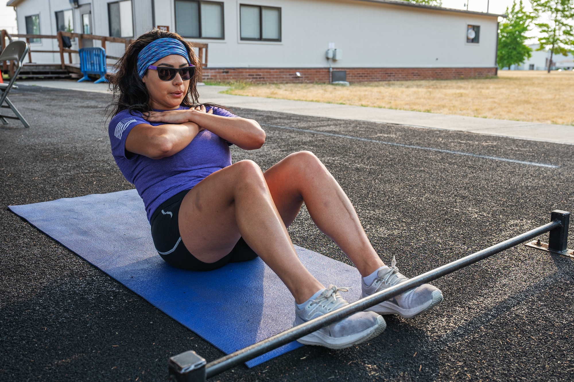 U.S. Air Force Capt. Estrella Cardenas, 627th Security Forces Squadron force support officer, completes sit-ups for the Dash for Danielle Memorial Run at Joint Base Lewis-McChord, Washington, Aug. 9, 2024.