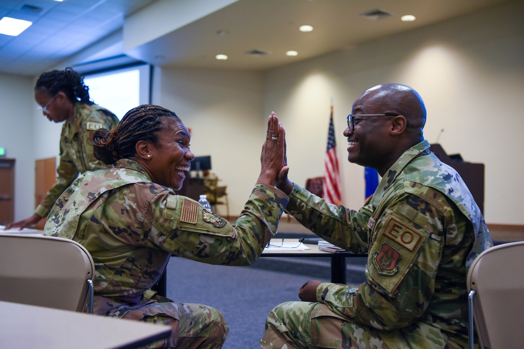 Two people high five.