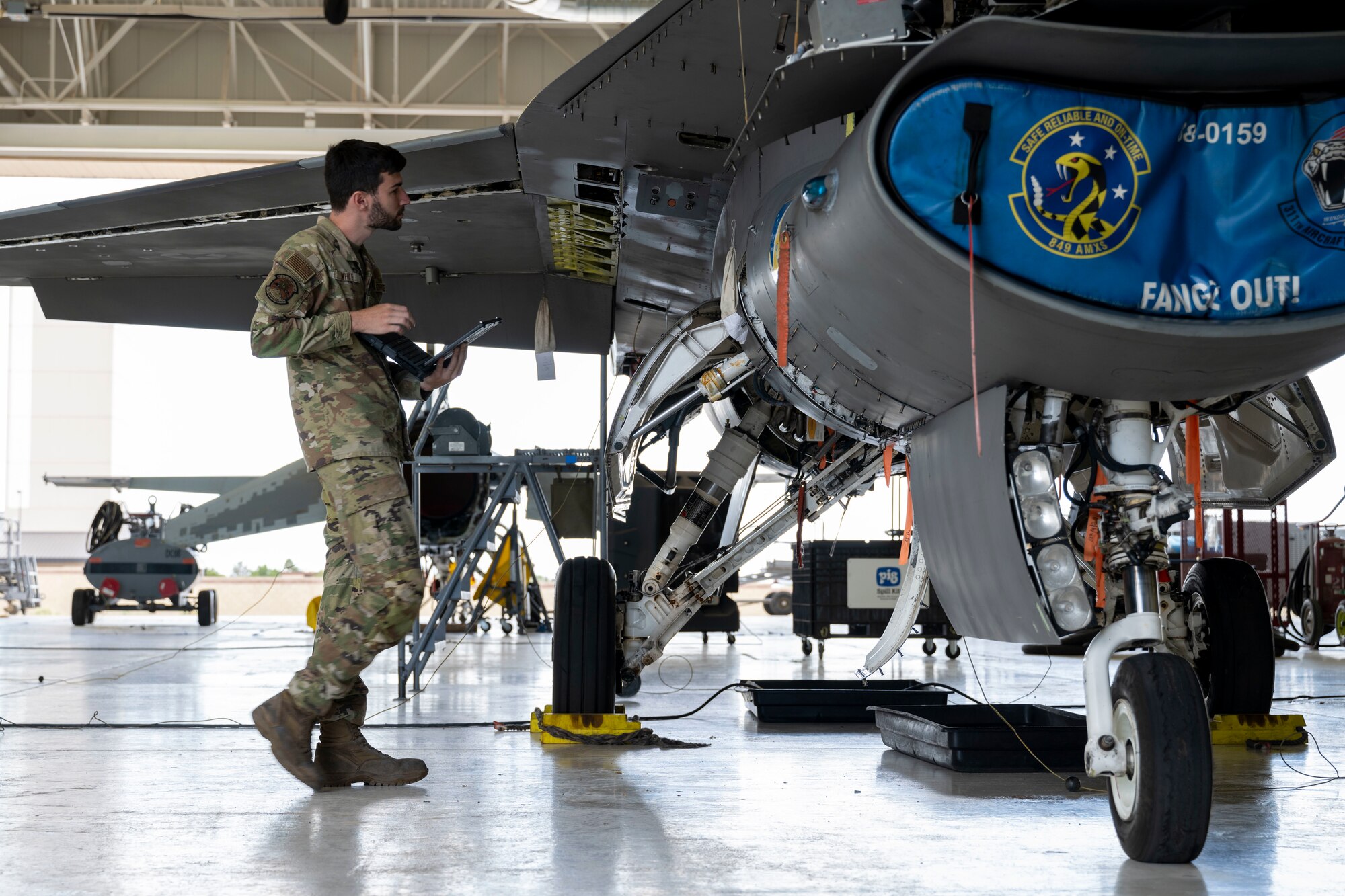 U.S. Air Force Staff Sgt. Joshua White, 372nd Training Squadron Detachment 25 aircraft fuels system technician, inspects an F-16 Viper at Holloman Air Force Base, New Mexico, Aug. 6, 2024.