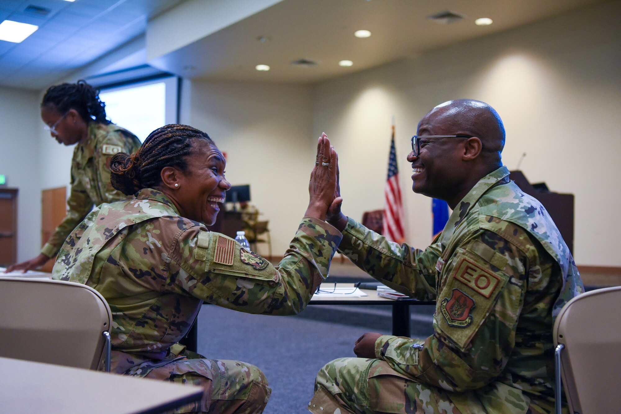 Two people high five.