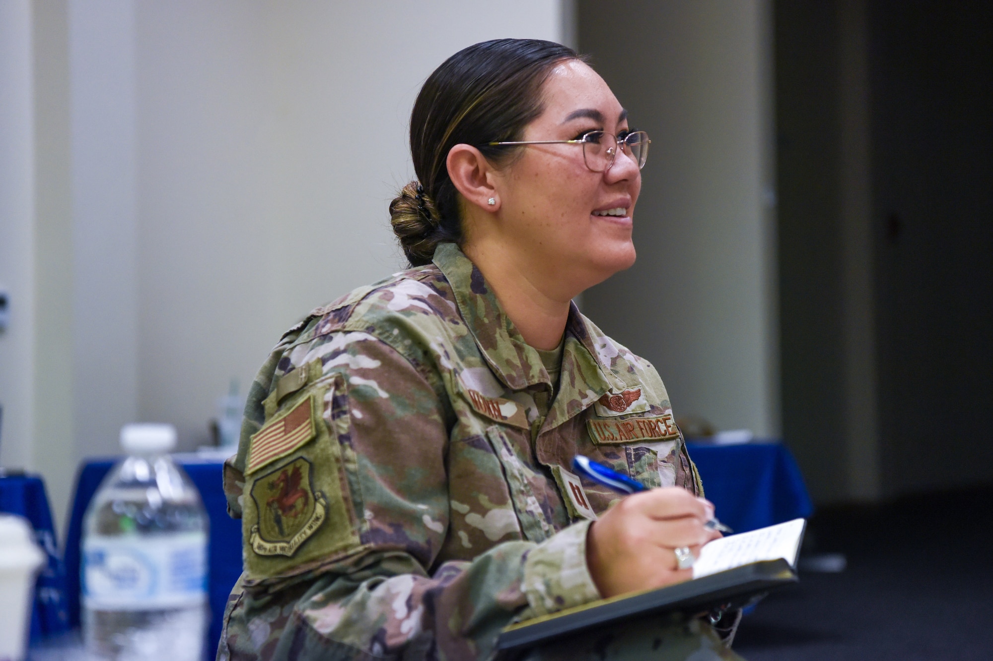 Woman writing in a notepad.