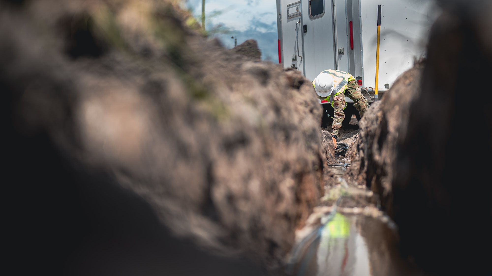 Airman digs for cable