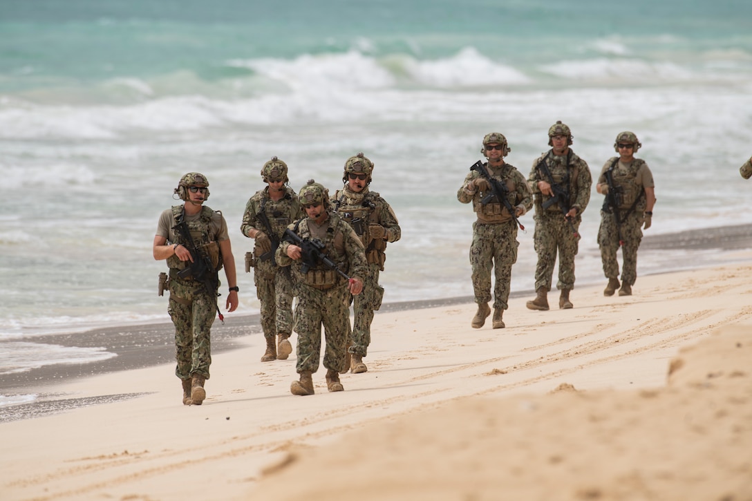 Coast Guardsmen from Port Security Unit 311, Shoreside Security Division perform as simulated enemy combatants during a mine clearing exercise at Bellows Air Force Station, Hawaii 24 during Exercise Rim of the Pacific (RIMPAC) July 24, 2024. 

Twenty-nine nations, 40 surface ships, three submarines, 14 national land forces, more than 150 aircraft and 25,000 personnel are participating in Rim of the Pacific Exercise (RIMPAC) in and around the Hawaiian Islands, June 27 to Aug. 1. 

The world’s largest international maritime exercise, RIMPAC provides a unique training opportunity while fostering and sustaining cooperative relationships among participants critical to ensuring the safety of sea lanes and security on the world’s oceans RIMPAC 2024 is the 29th exercise in the series that began in 1971.