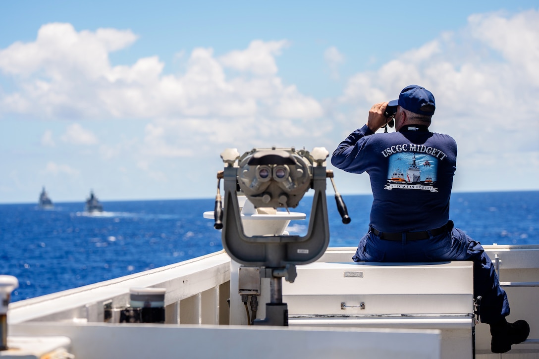 Cmdr. Donald Striker, executive officer of the U.S. Coast Guard Cutter Midgett scans the horizon while sailing in formation with the Royal Brunei Navy offshore patrol vessels KDB Darussalam (OPV 06) and Darulaman (OPV 08) steam alongside the Italian Navy offshore patrol vessel ITS Montecuccoli at Exercise Rim of the Pacific 2024 off the coast of Hawaii, July 19. Twenty-nine nations, 40 surface ships, three submarines, 14 national land forces, more than 150 aircraft and 25,000 personnel are participating in RIMPAC in and around the Hawaiian Islands, June 27 to Aug. 1. The world's largest international maritime exercise, RIMPAC provides a unique training opportunity while fostering and sustaining cooperative relationships among participants critical to ensuring the safety of sea lanes and security on the world's oceans. RIMPAC 2024 is the 29th exercise in the series that began in 1971. (U.S. Coast Guard Photo by David Lau)