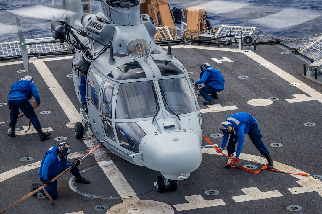 The U.S. Coast Guard helicopter tie-down team aboard legend-class cutter USCGC Midgett (WMSL 757) secures a Mexican navy Panther Helicopter ANX 2161 during Exercise Rim of the Pacific (RIMPAC) 2024 off the coast of Hawaii, July 14. Twenty-nine nations, 40 surface ships, three submarines, 14 national land forces, more than 150 aircraft and 25,000 personnel are participating in RIMPAC in and around the Hawaiian Islands, June 27 to Aug. 1. The world’s largest international maritime exercise, RIMPAC provides a unique training opportunity while fostering and sustaining cooperative relationships among participants critical to ensuring the safety of sea lanes and security on the world’s oceans. RIMPAC 2024 is the 29th exercise in the series that began in 1971. (U.S. Coast Guard photo by David Lau)